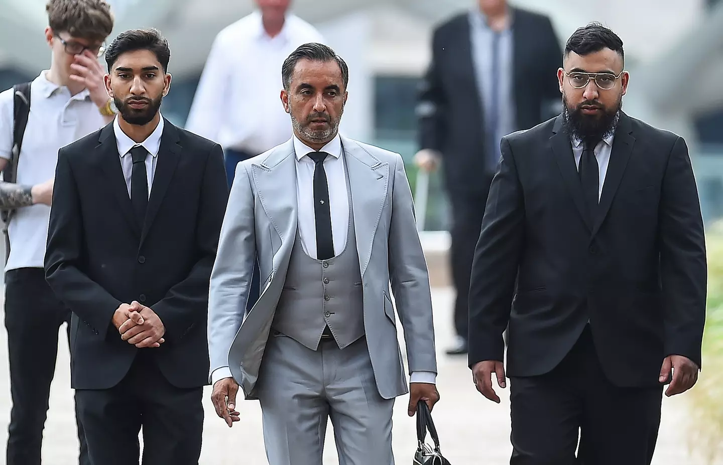 Human Rights lawyer Aamer Anwar with Mohammed Fahir Amaaz (left) and Muhammed Amaad (right) arriving at Liverpool Crown Court last year (PA)