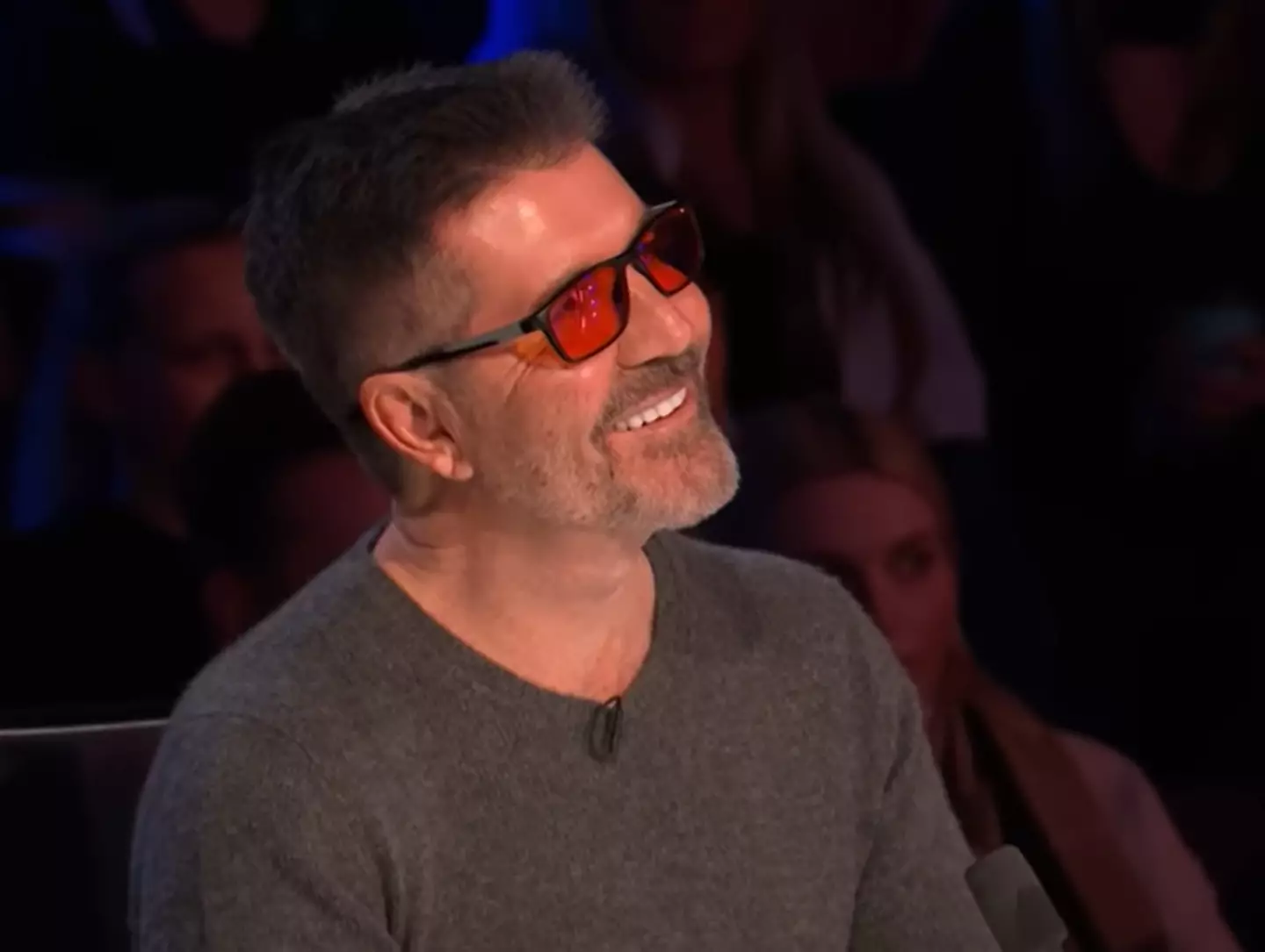 The red-tinted glasses help keep out the worst of the bright lights and can spare Simon from migraines. (ITV)