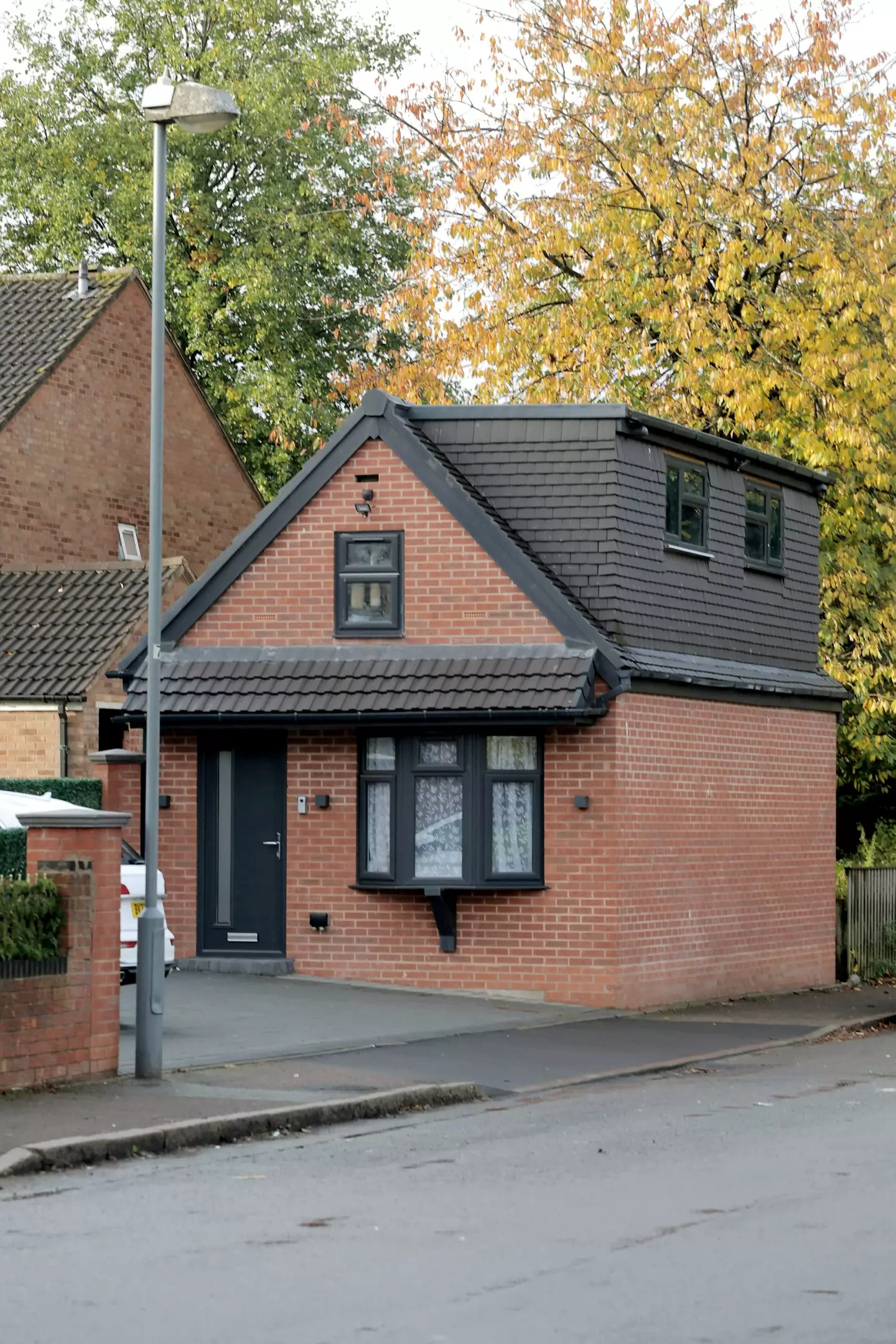 A man who built a detached house on his driveway without permission has finally had it partially removed.