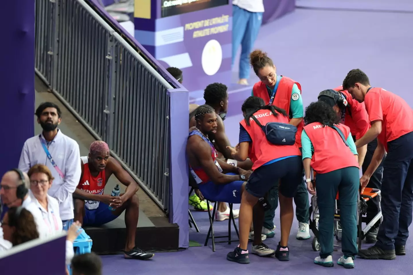 The American sprinter received medical treatment after the race. (Simon Bruty/Sports Illustrated via Getty Images)
