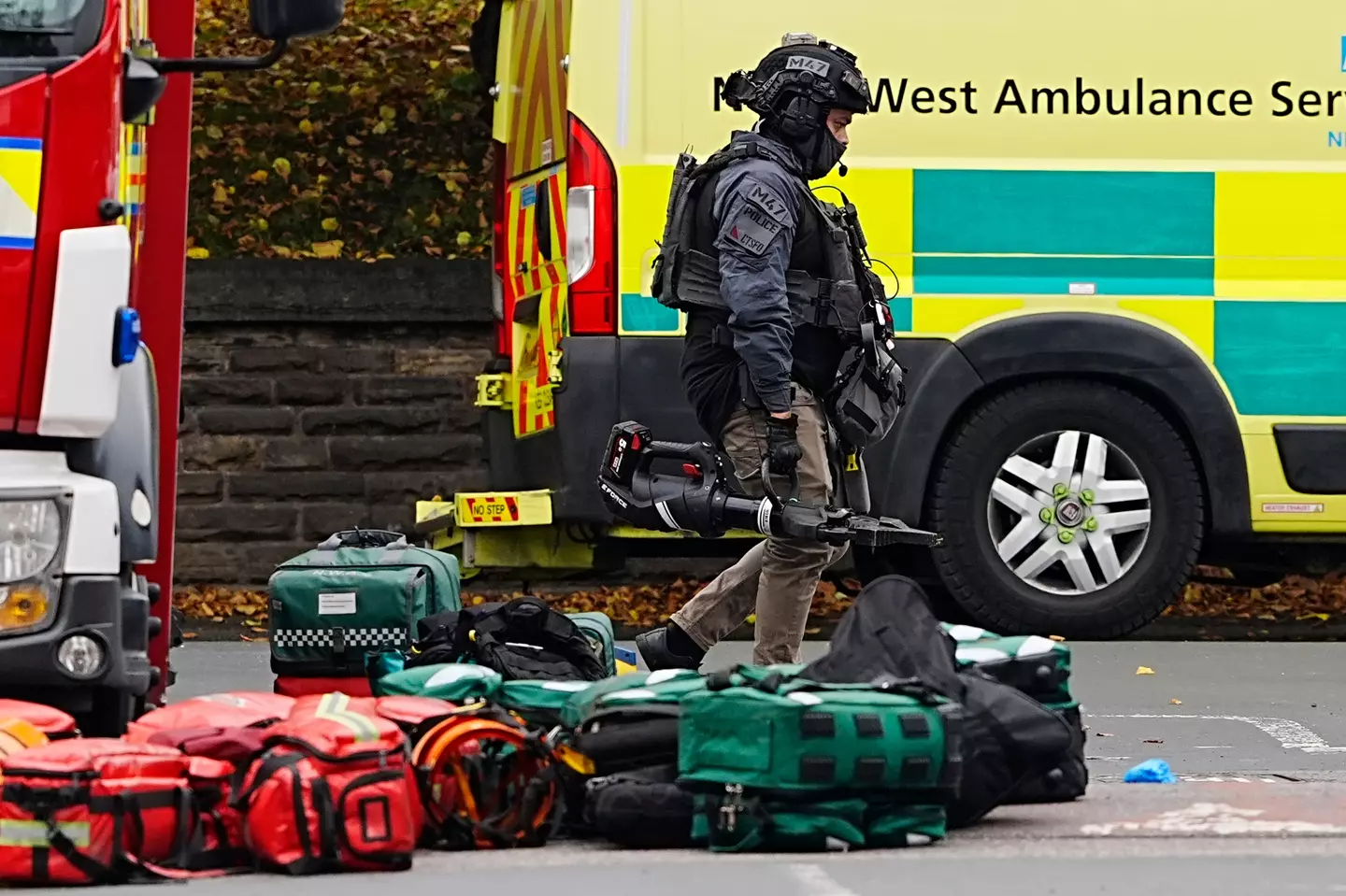 Armed officers remain on the scene of the crime, which has so far seen two people be killed (PA)