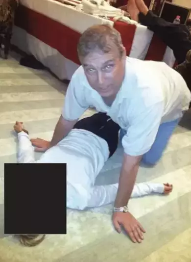 The latest documents included an image of Epstein on all fours kneeling over a woman (DoJ)