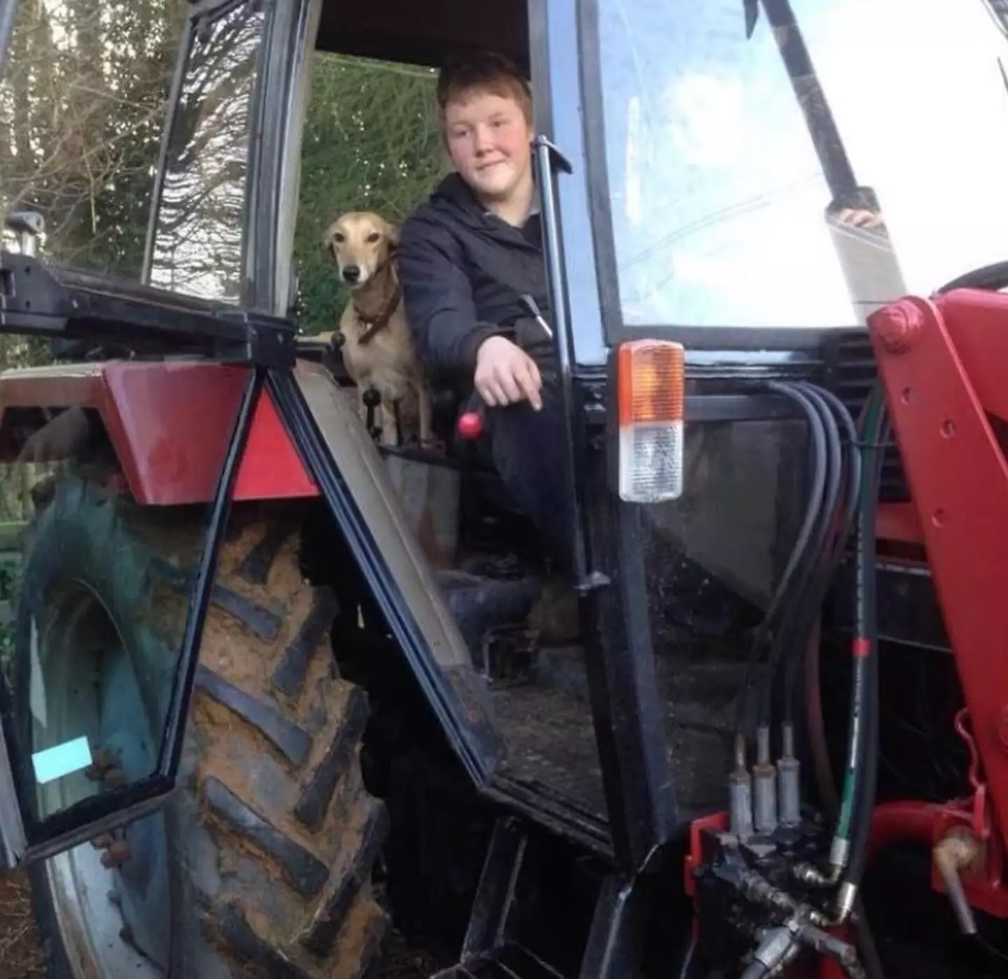 Kaleb with his first tractor, aged 15.