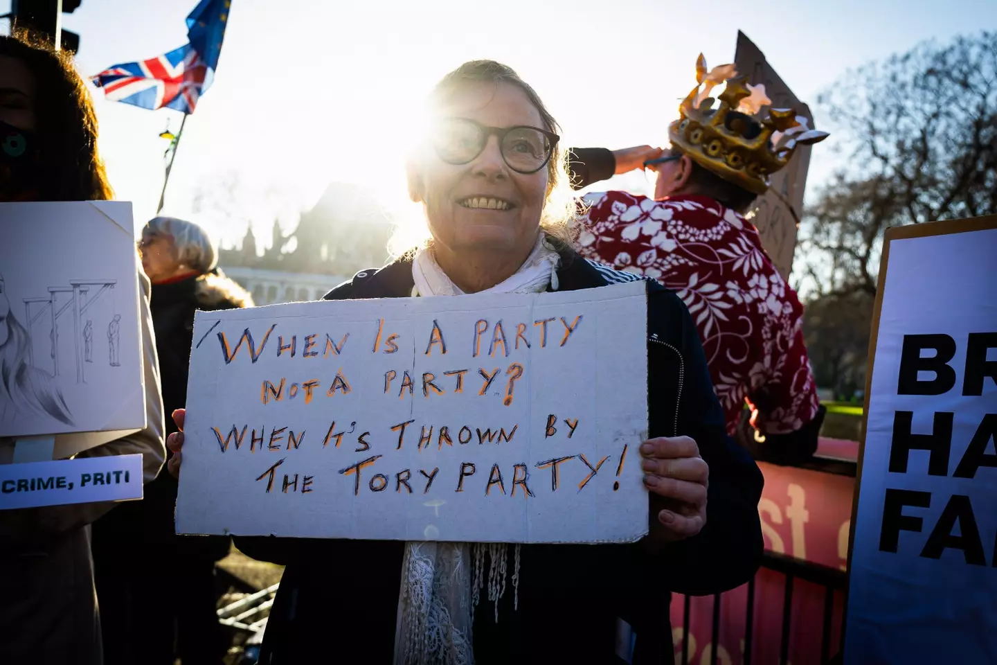 A protester holding a sign about the Number 10 party in May 2020.