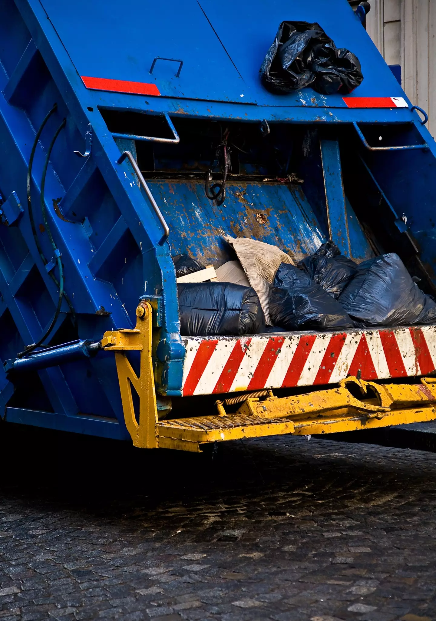 A woman was rescued from the back of a bin lorry after being compacted four times in there.