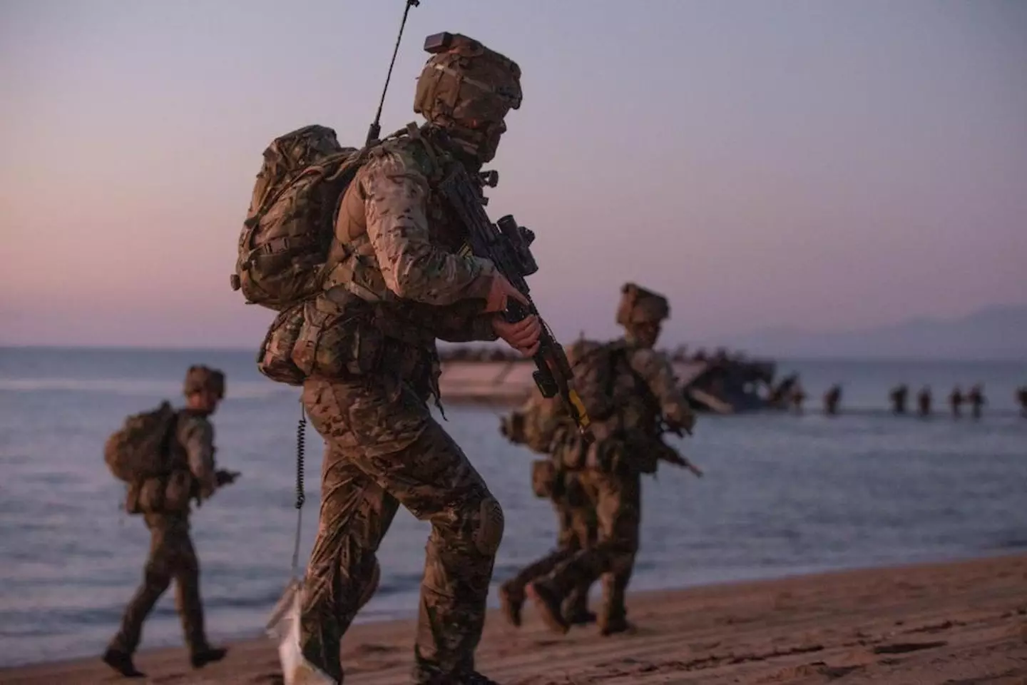 A group of bemused fishermen noticed the 30 commandos making their way up the beach.