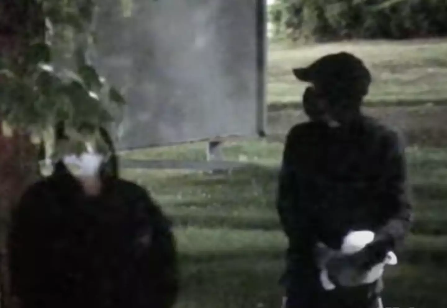 One figure appears to be holding something wrapped in a white plastic bag.