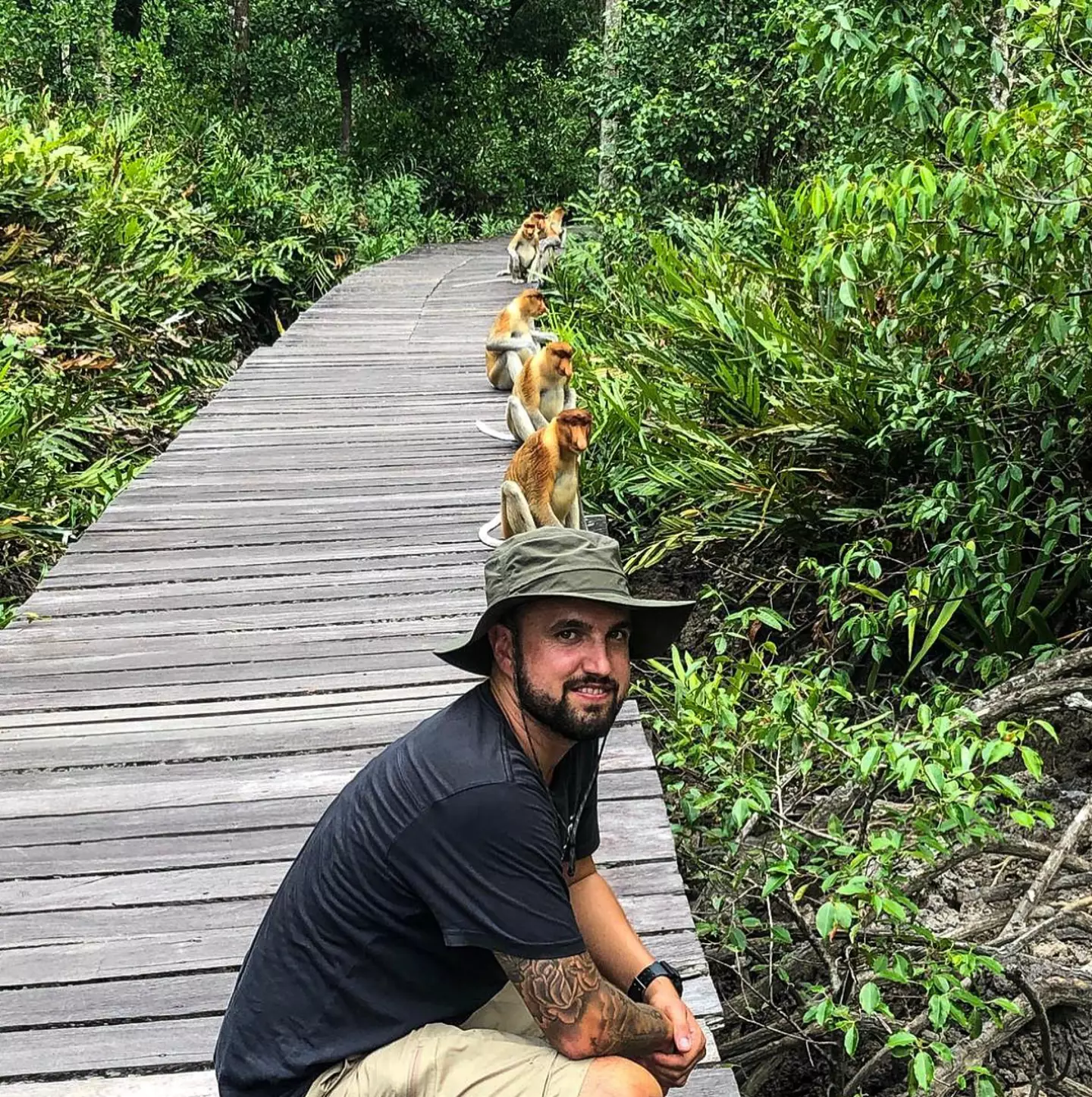 David Alphonso posing with probiscus monkeys.