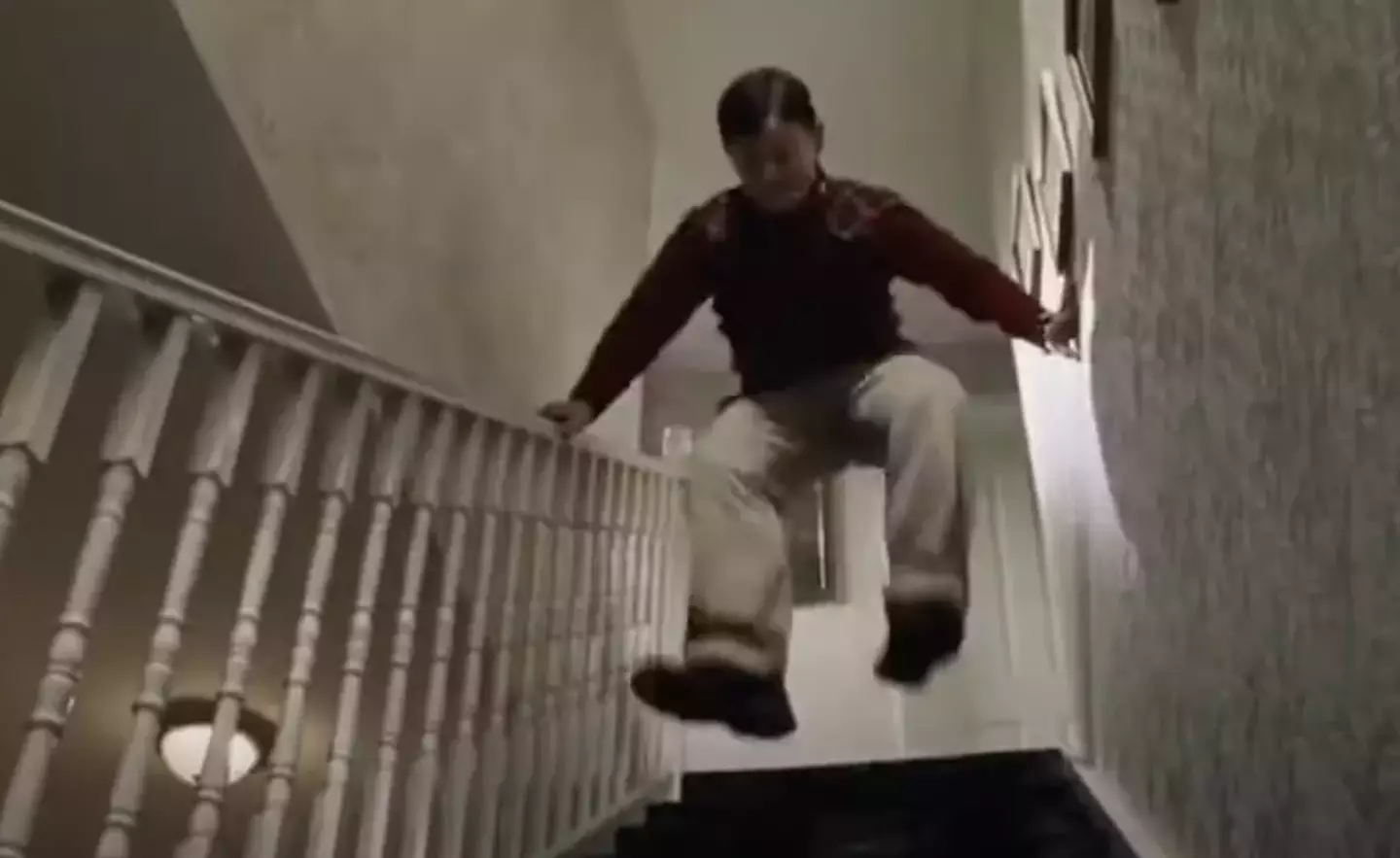 Dudley stomps down the stairs to wake Harry.