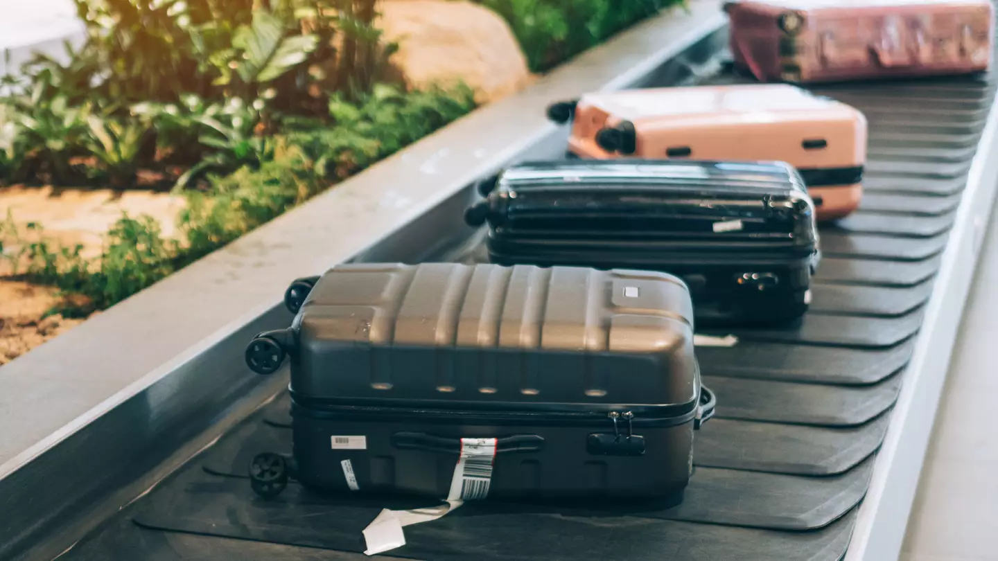 Avoid dark coloured suitcases at an airport (Getty Stock)
