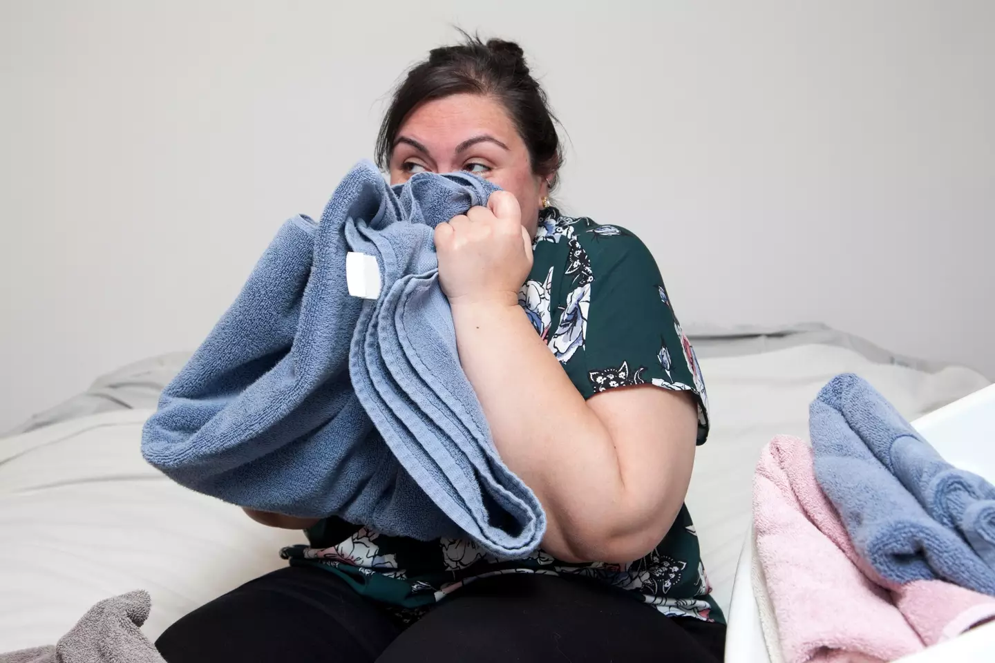 Woman smelling towels (