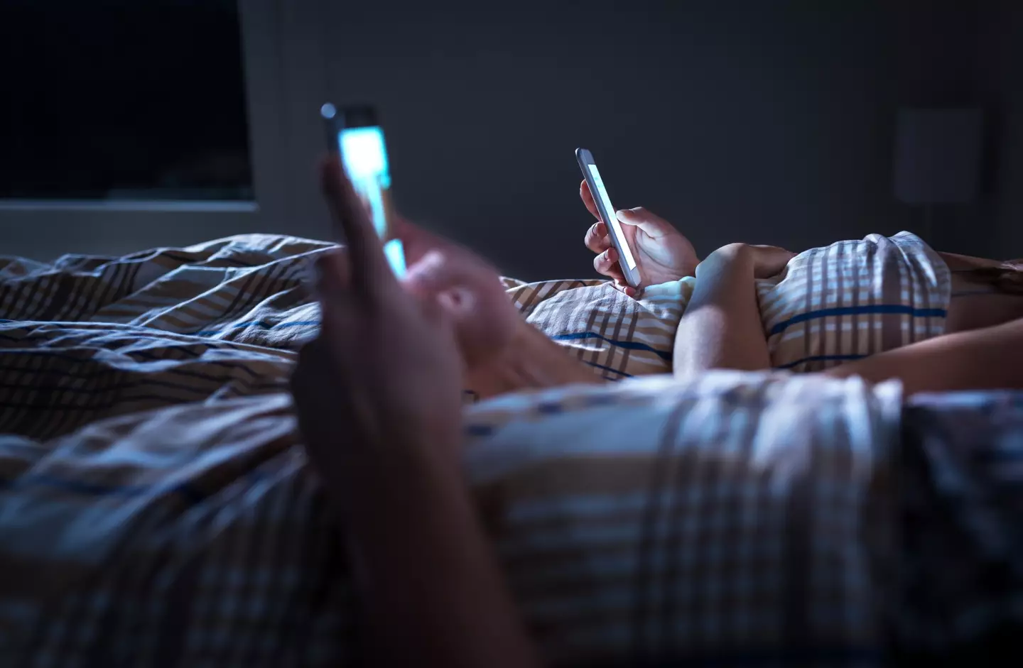 Using your phone in bed may not be the smartest idea (Getty Stock Photo)