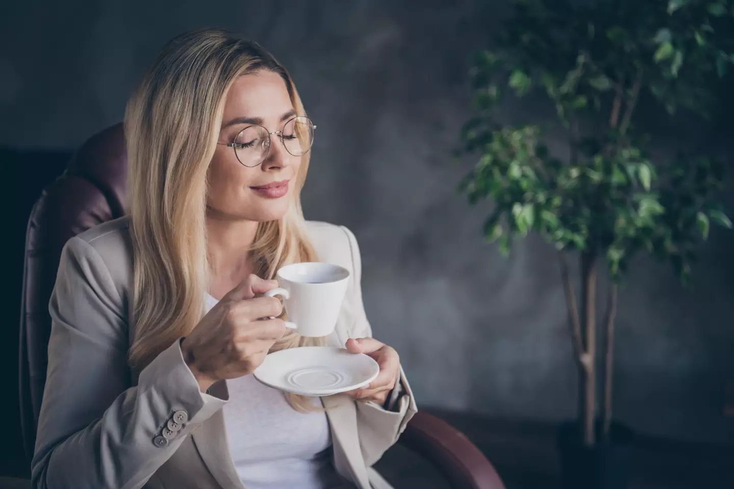 Woman smelling coffee (