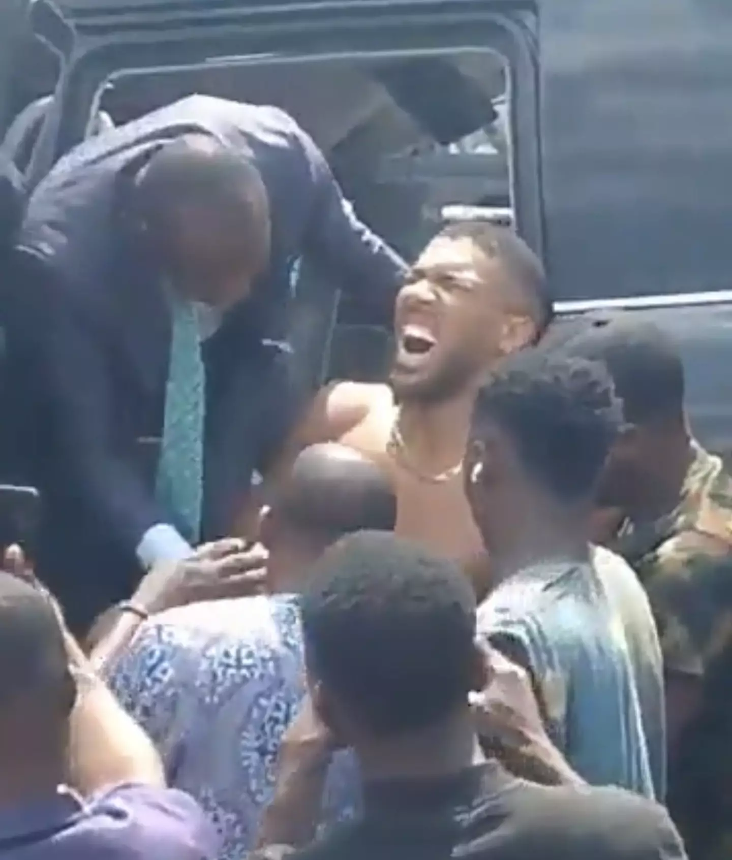 Anthony Joshua was shown being taken out of the car by passersby (X)