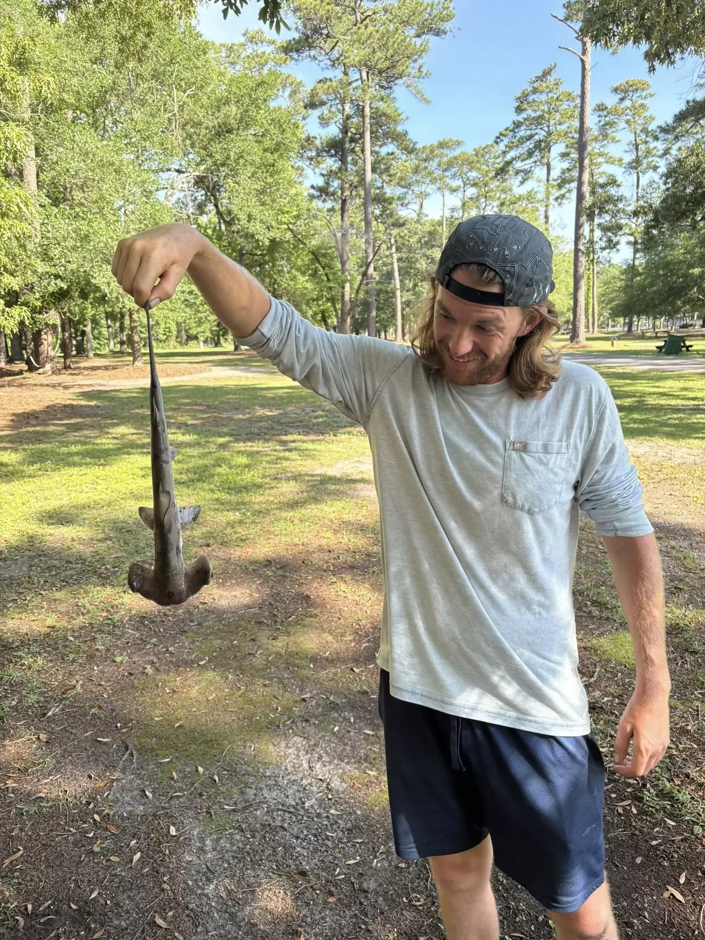 Jonathon holding up his catch like a prize fish (Facebook/Jonathon Marlowe)