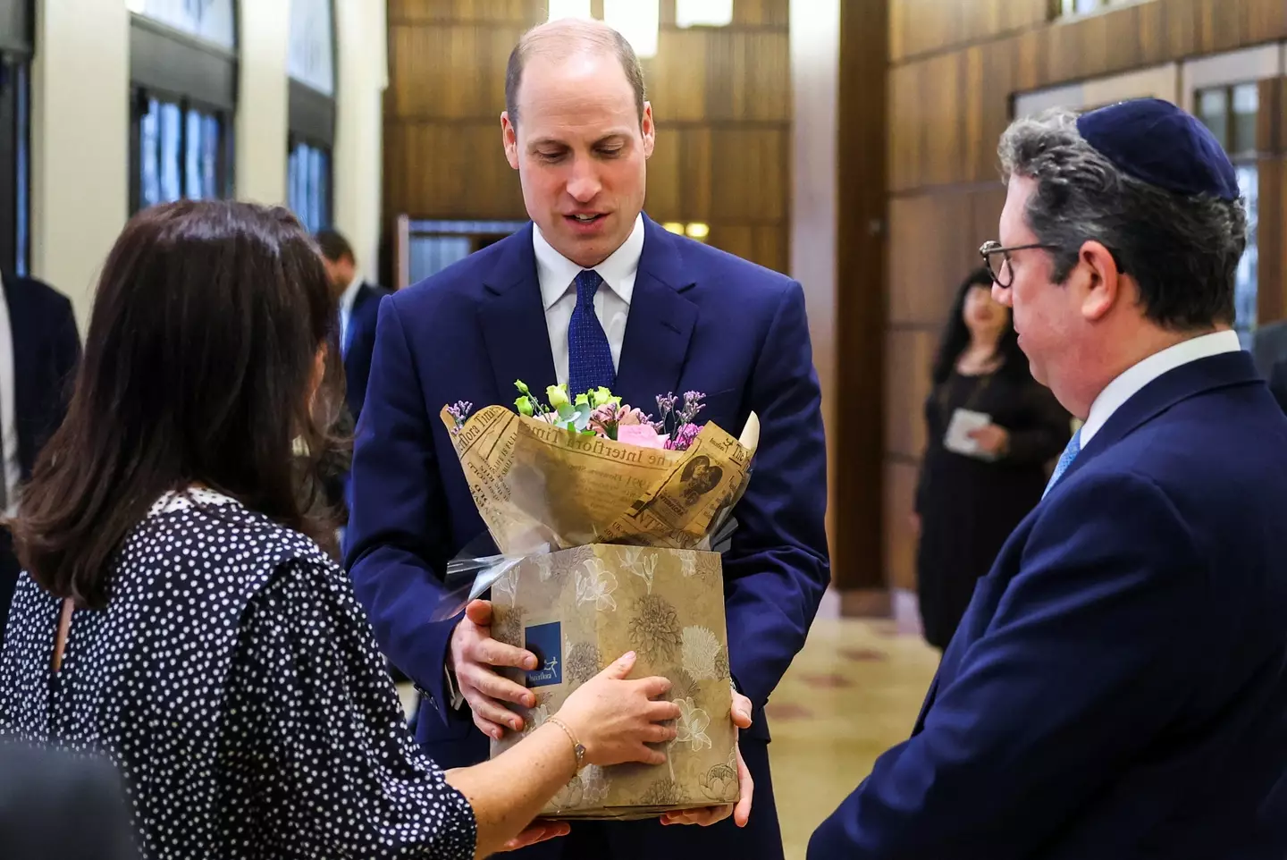 Prince William returned to royal duties today, and was presented with flowers for his wife.