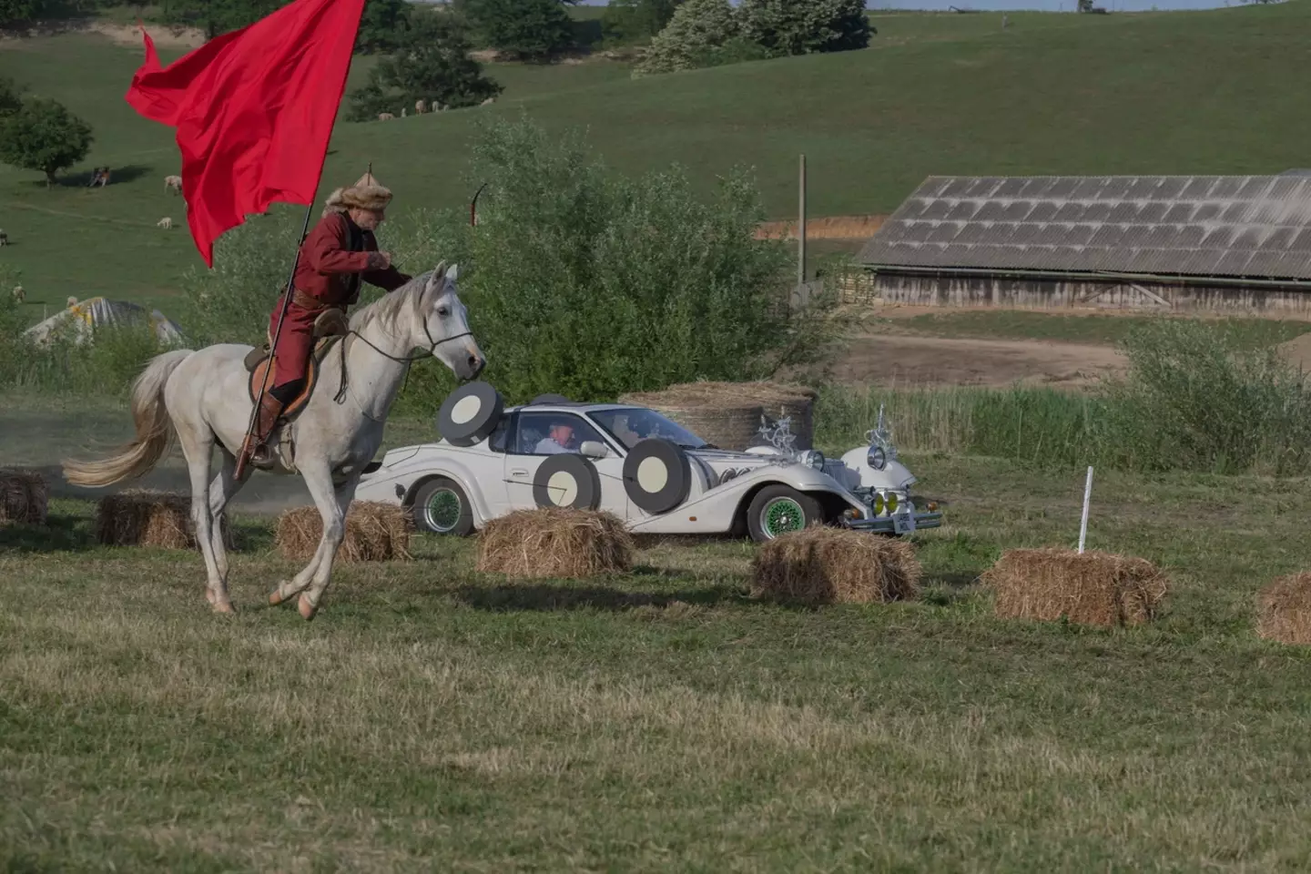 Jeremy Clarkson drives alongside a man on horseback in The Grand Tour: Eurocrash.