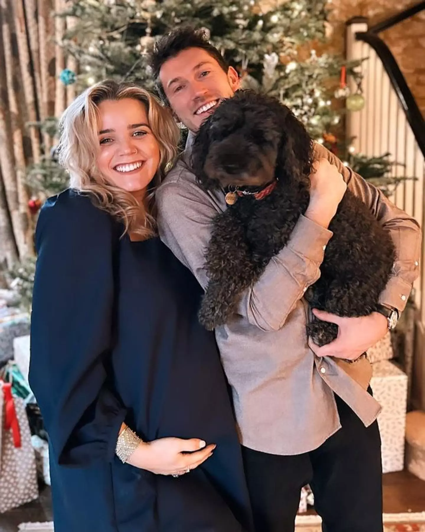 The happy couple and their pooch announcing that they were expecting.