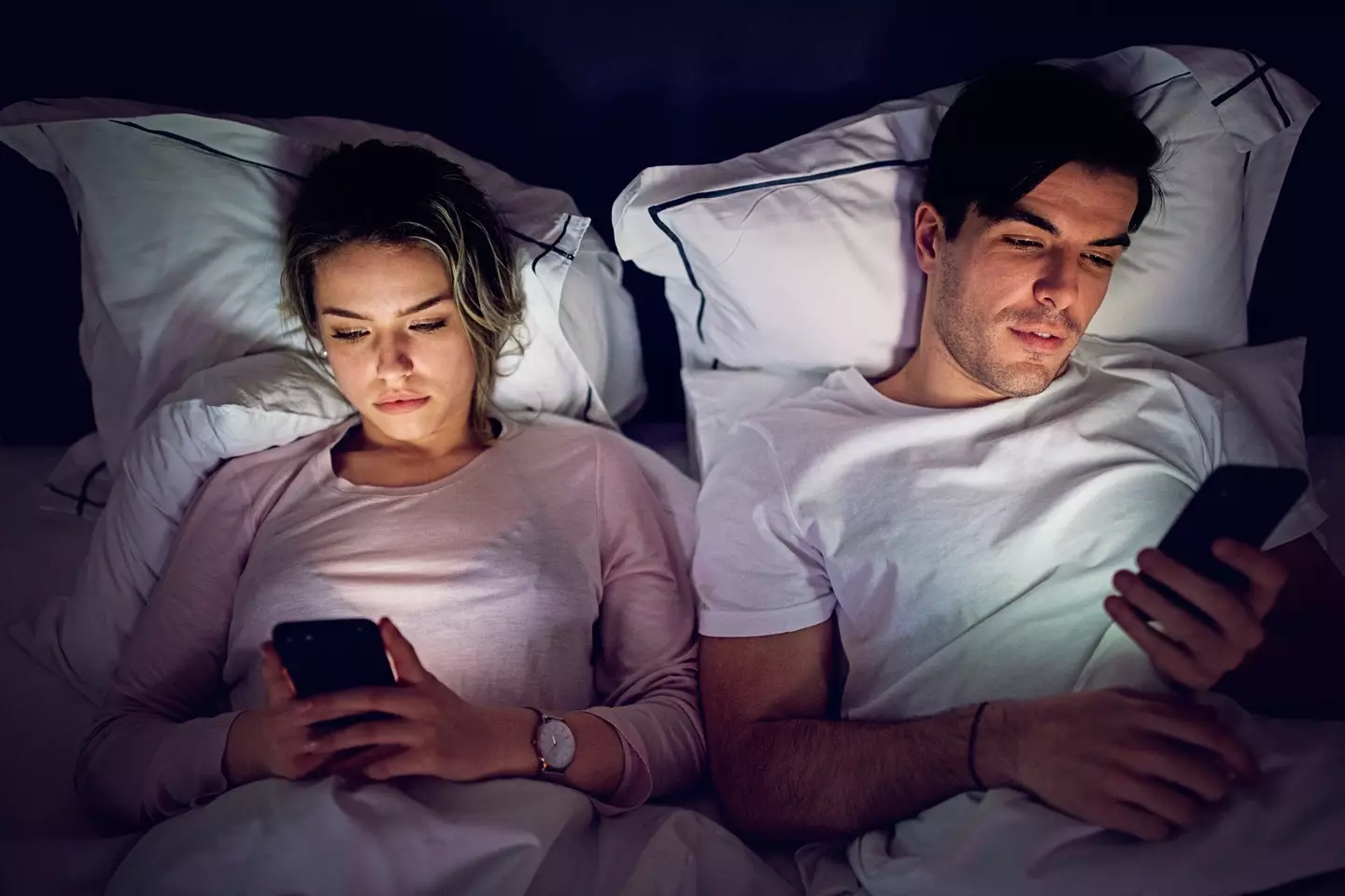 What came first, the moribund sex life or the scrolling on phones being the only bedroom action? (Getty Stock Photo)