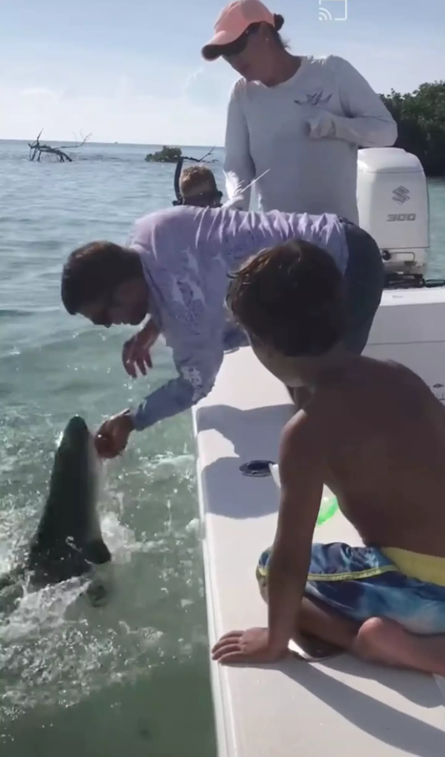 The shark suddenly latched onto his finger as he tried to remove the hook.