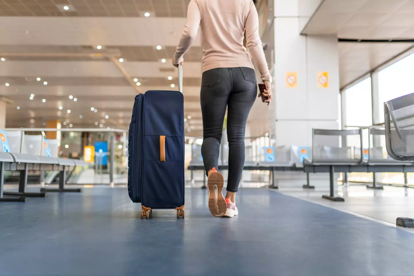 A woman on the way to check in her luggage (Getty Stock Images)