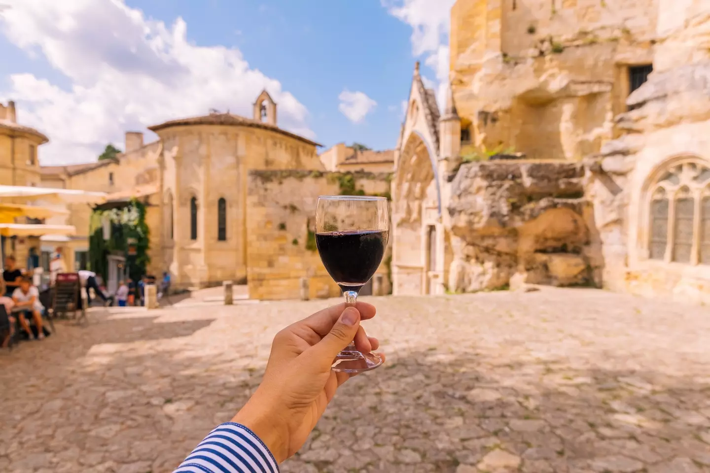 Man drinking red wine in Saint-Emilion village, Bordeaux.