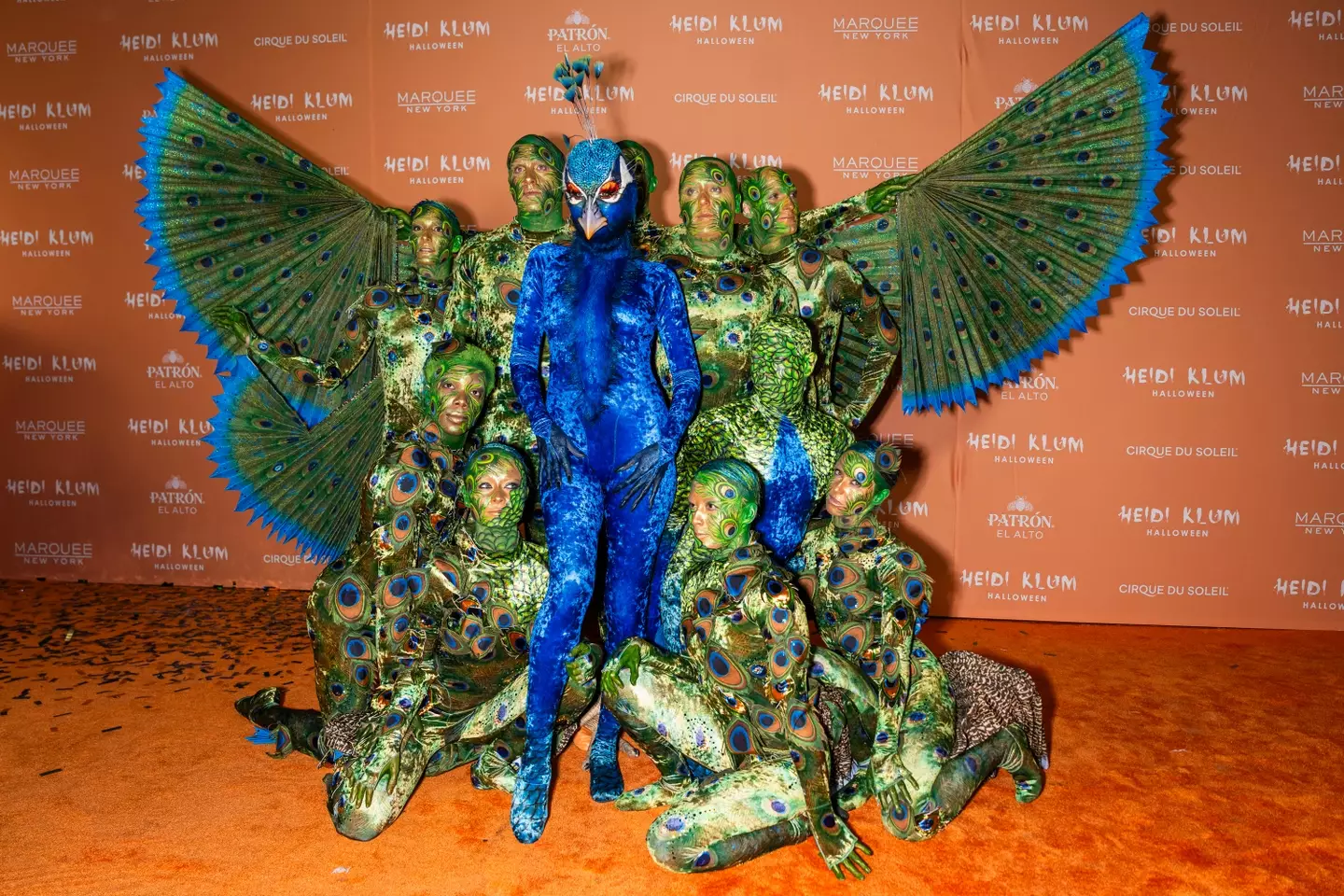 Heidi Klum dressed as a peacock this Halloween, with a bit of help from others.