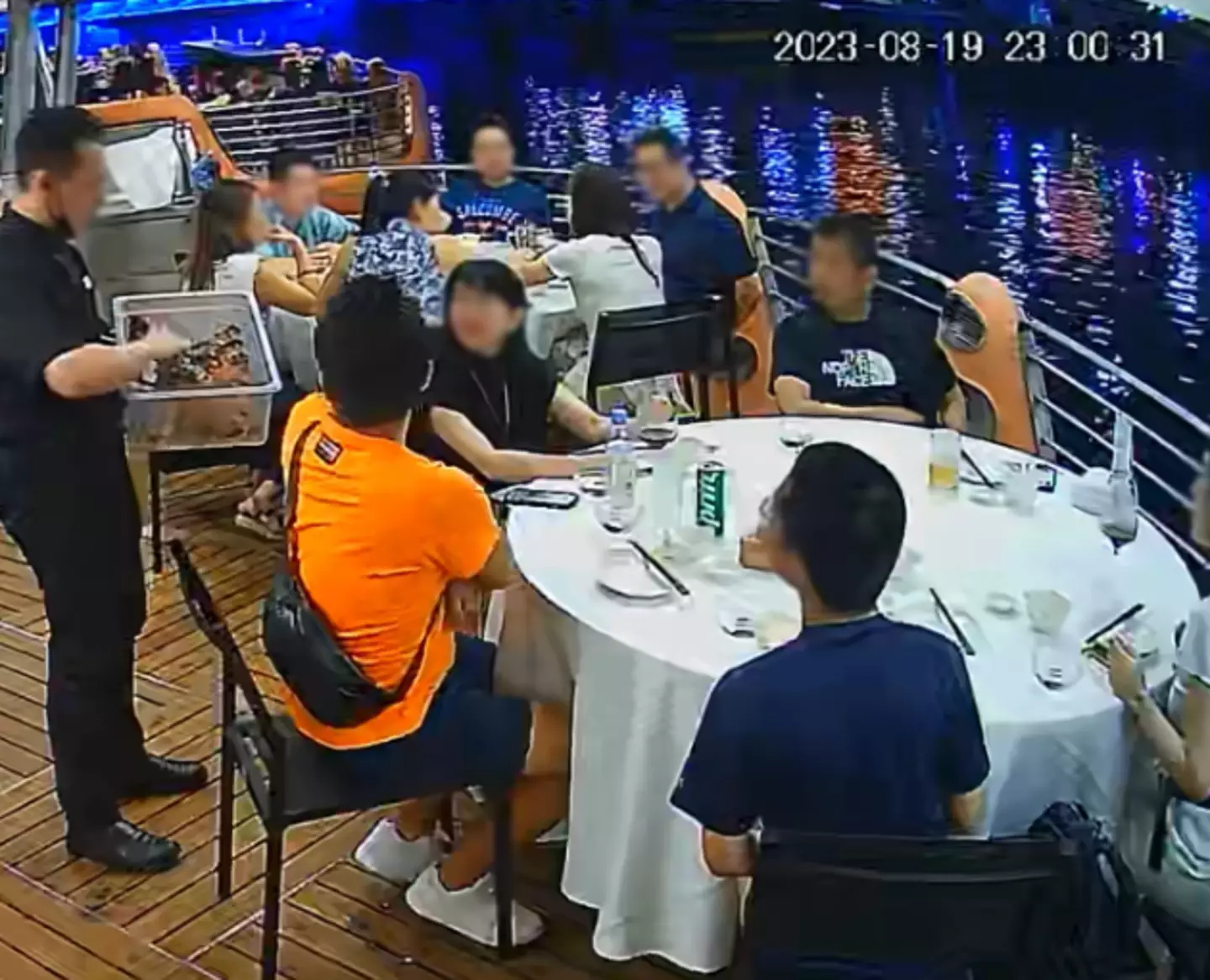A CCTV image of a waiter showing the table the crab.