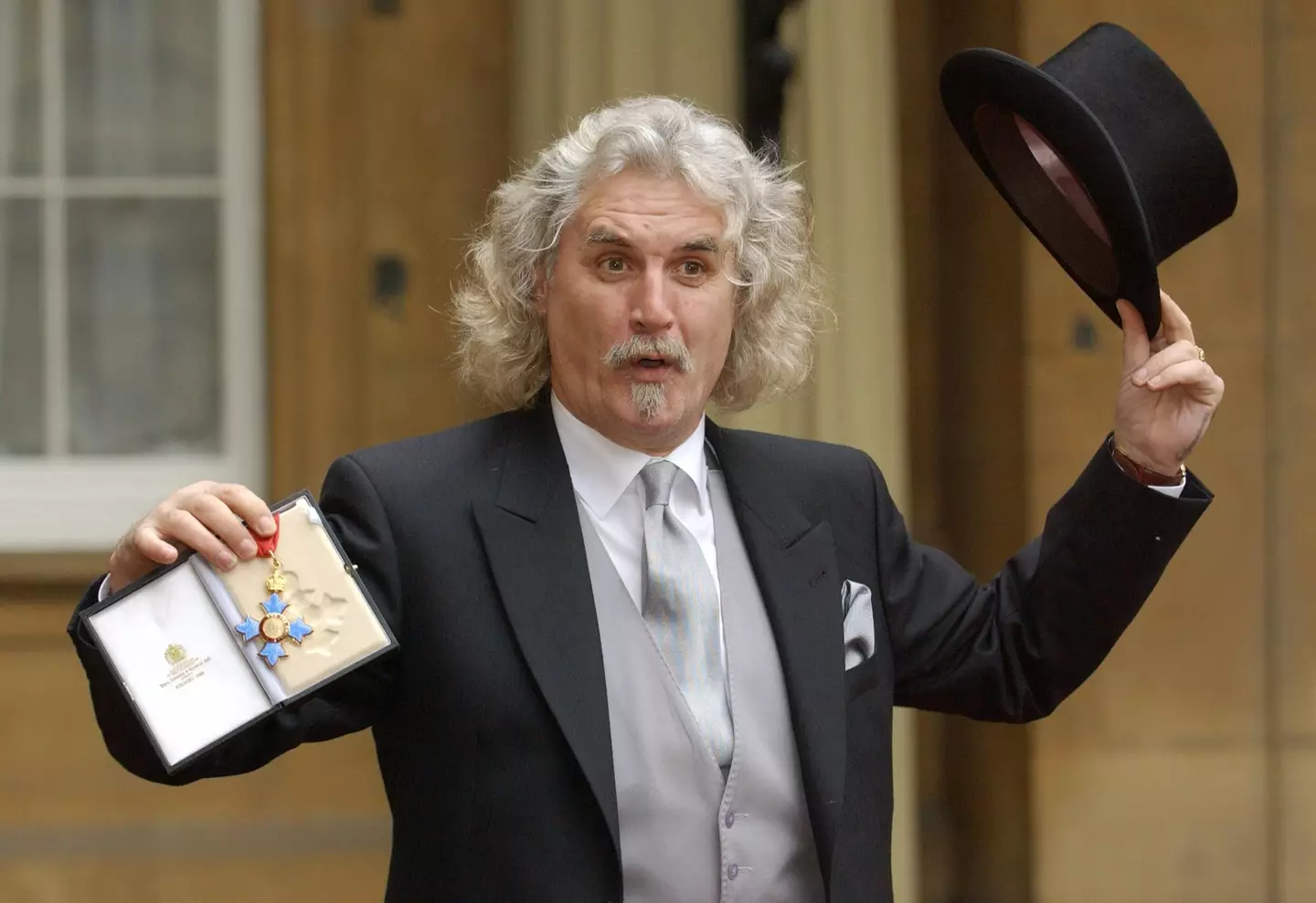Billy Connolly showing off his CBE in 2003.