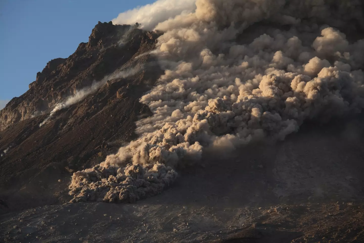 You can't outrun a pyroclastic flow and when it engulfs you it'll cook you alive, and also possibly make your head explode.