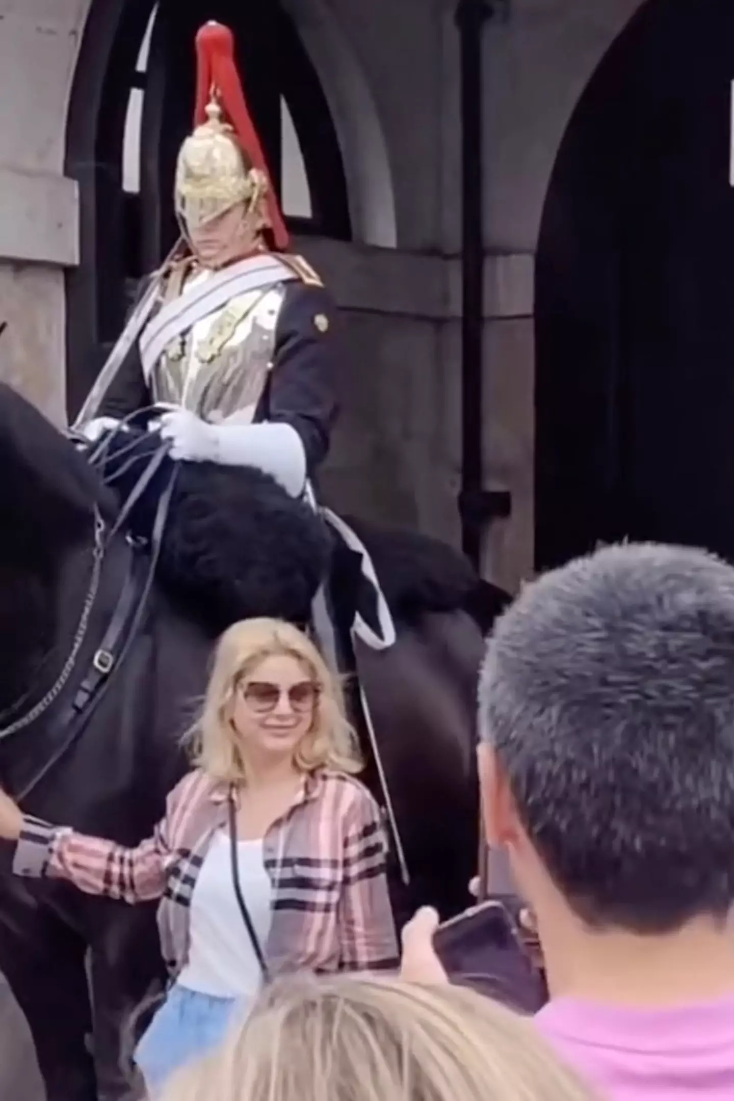 The woman tried to get a sneaky pic with the horse.