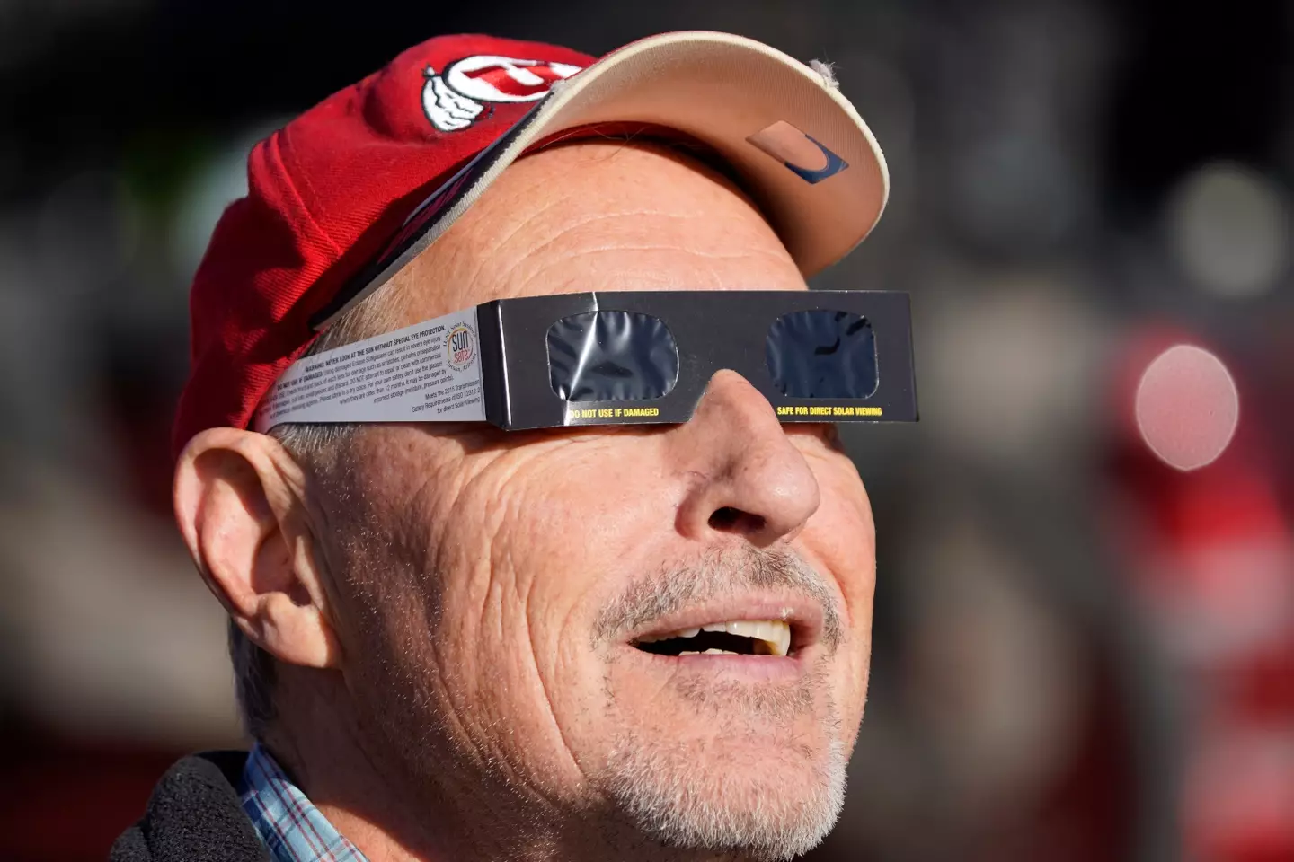 A man safely watching an eclipse as it happens.