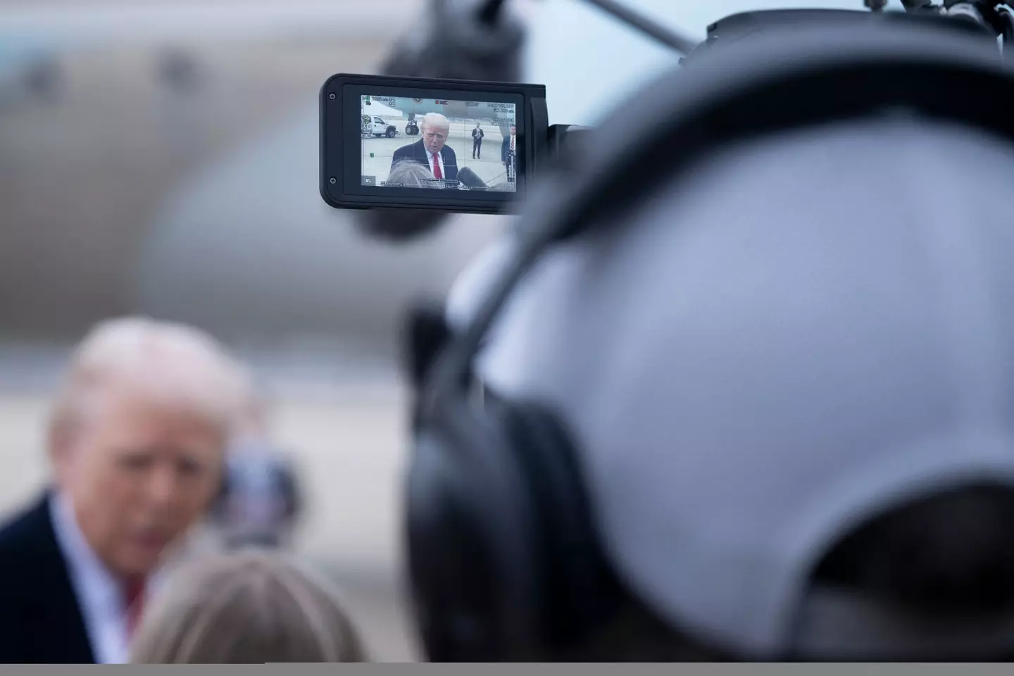 Those fluffy things are boom mics, someone caught Trump in the face with one (BRENDAN SMIALOWSKI/AFP via Getty Images)