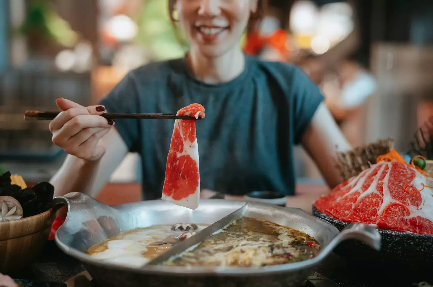 The woman was enjoying a hot pot meal with a friend.