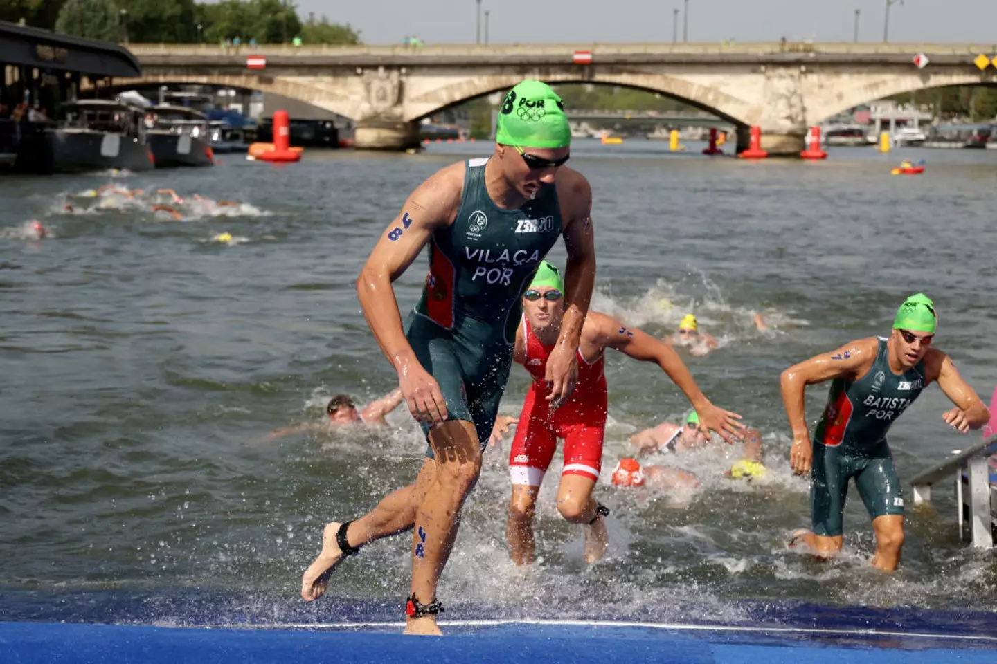 Triathlon swimmers can be seen leaving the Seine (Ezra Shaw/Getty Images)