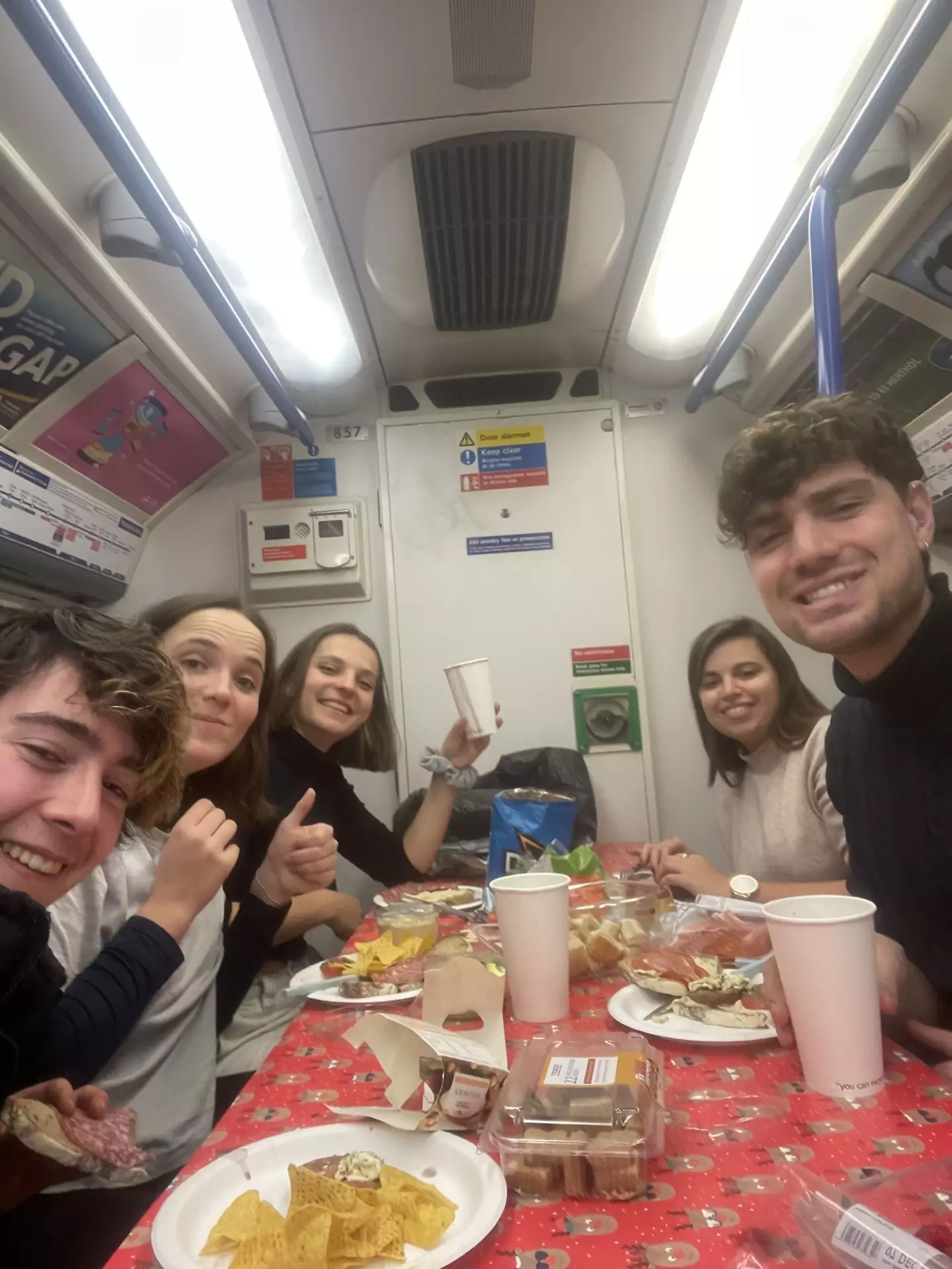 A group of students celebrated Christmas by taking their own dinner and dining table on the London tube.