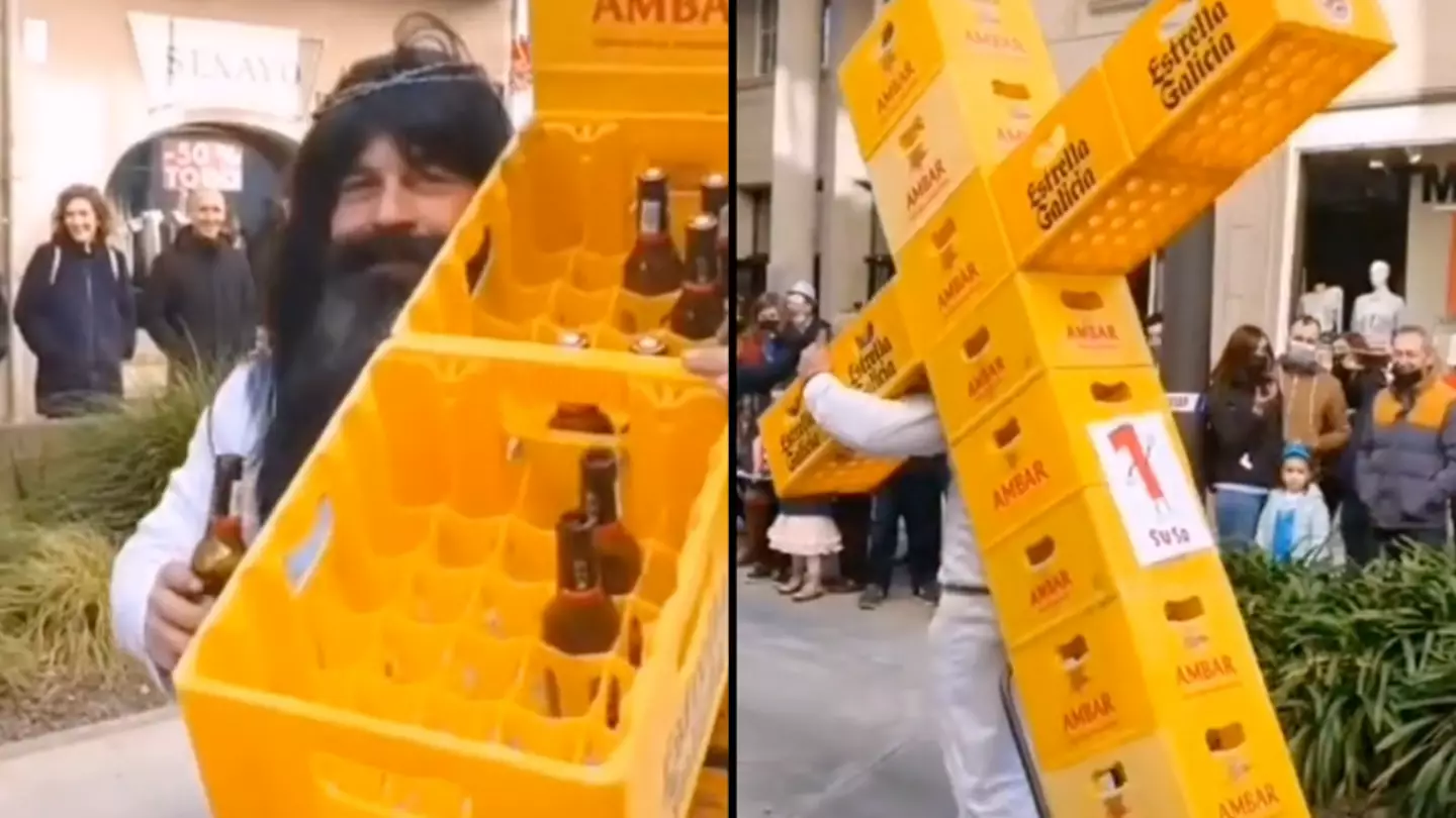 Man Dressed As Jesus Christ Seen Pulling A Cross Made Out Of Beer Crates