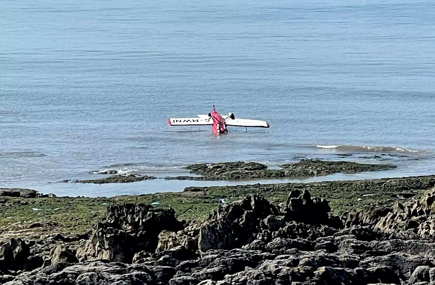 Witnesses to the crash said the pilot had a 'very near miss' after they narrowly avoided crashing onto the rocks.