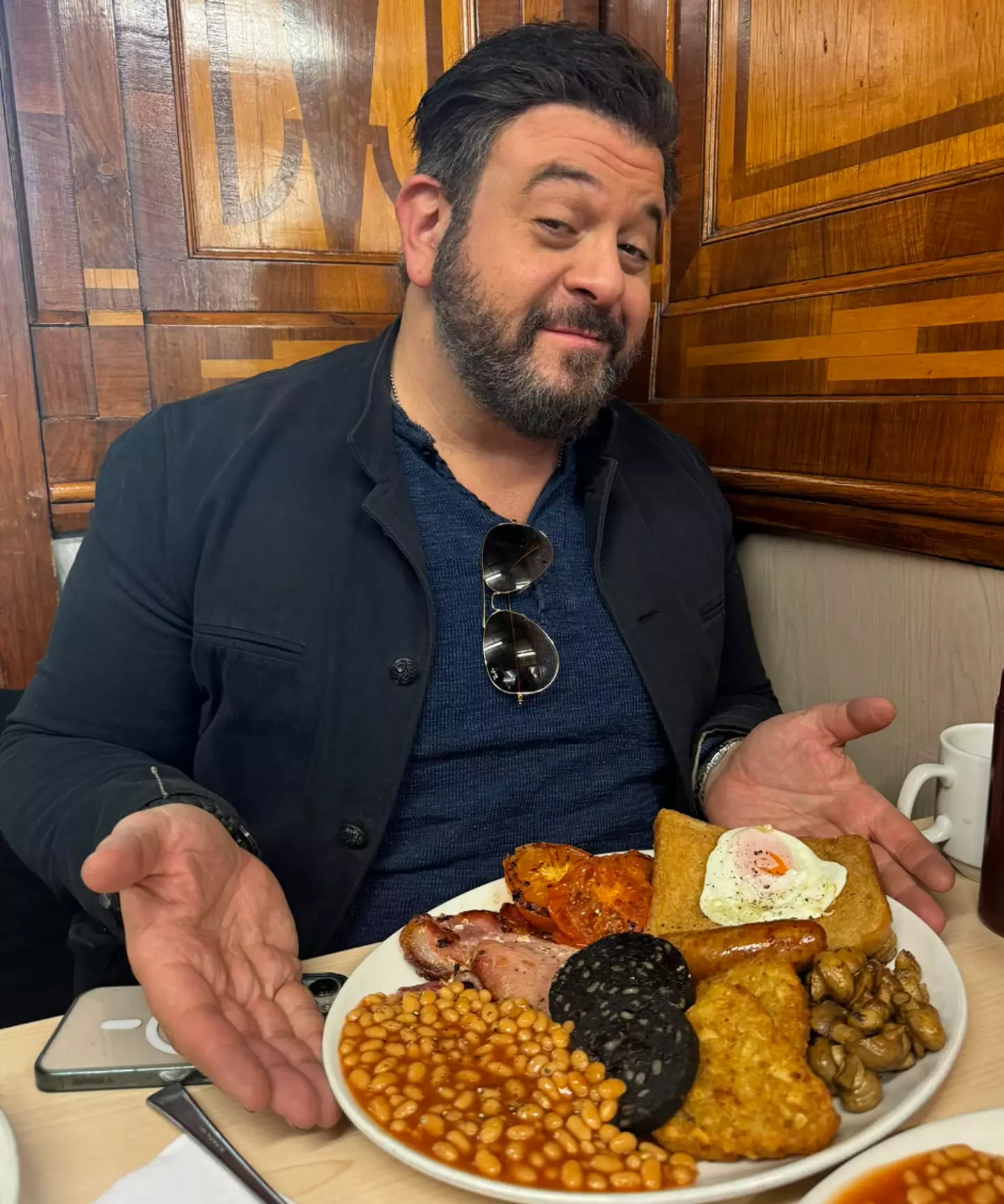 Adam Richman posing proudly with his Full English.