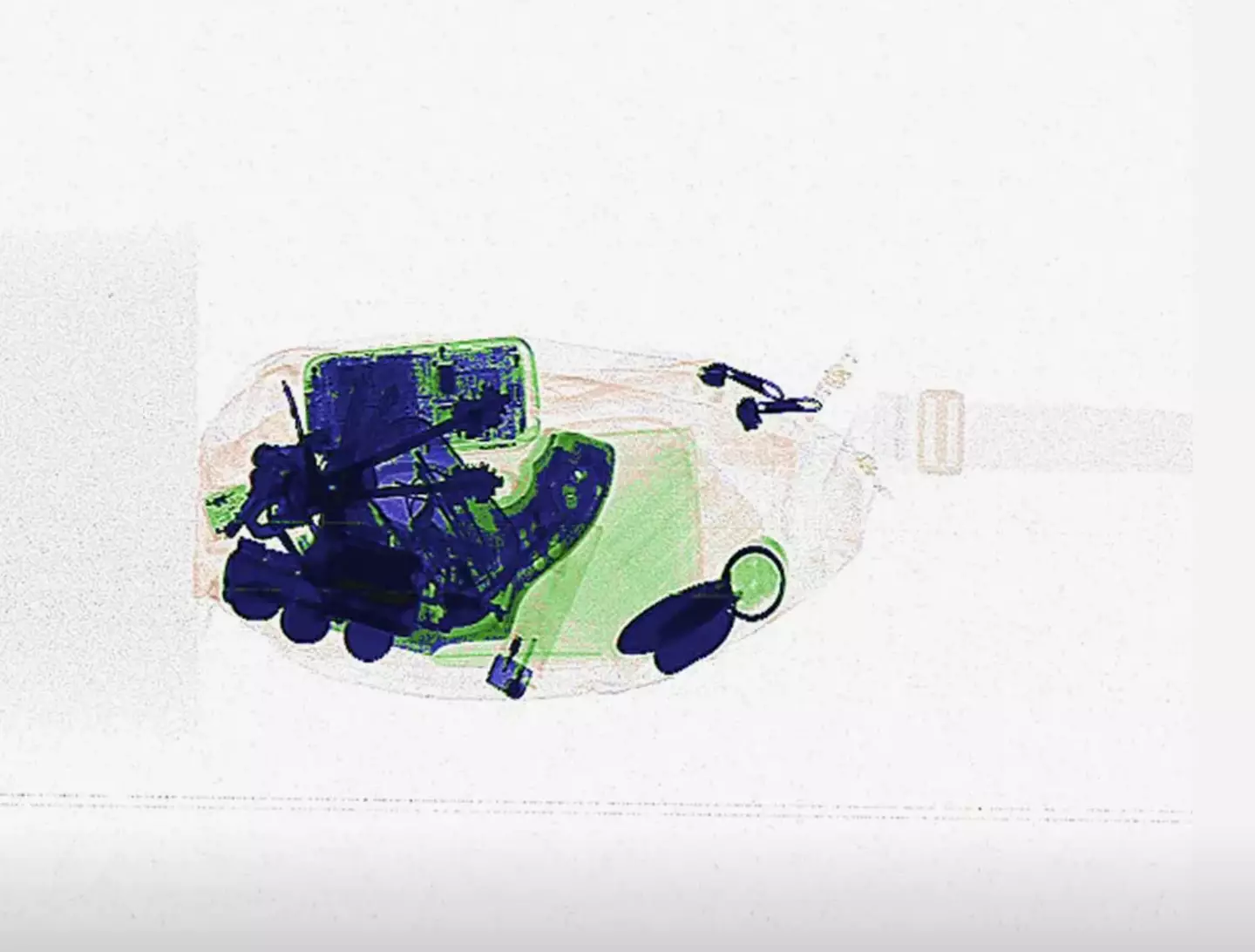 The object is partially visible amongst other items in the bag (Simulscan)