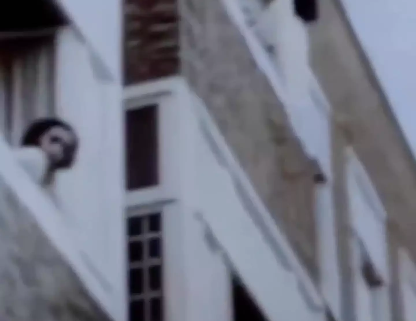 Anne Frank, who was around 12 at the time, can be seen looking out of her window.