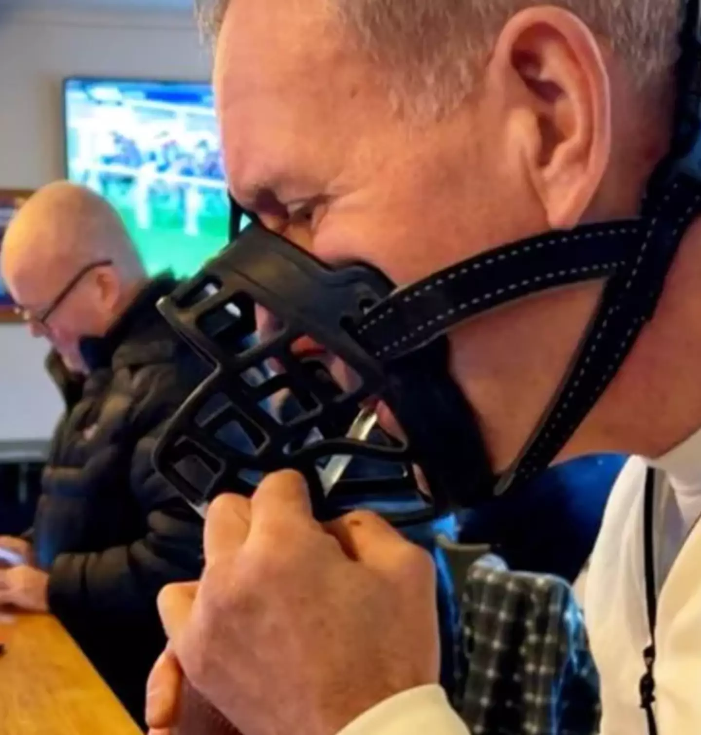 A dad has made his attentions clear against the new XL bully laws by drinking in his local pub with a muzzle on.