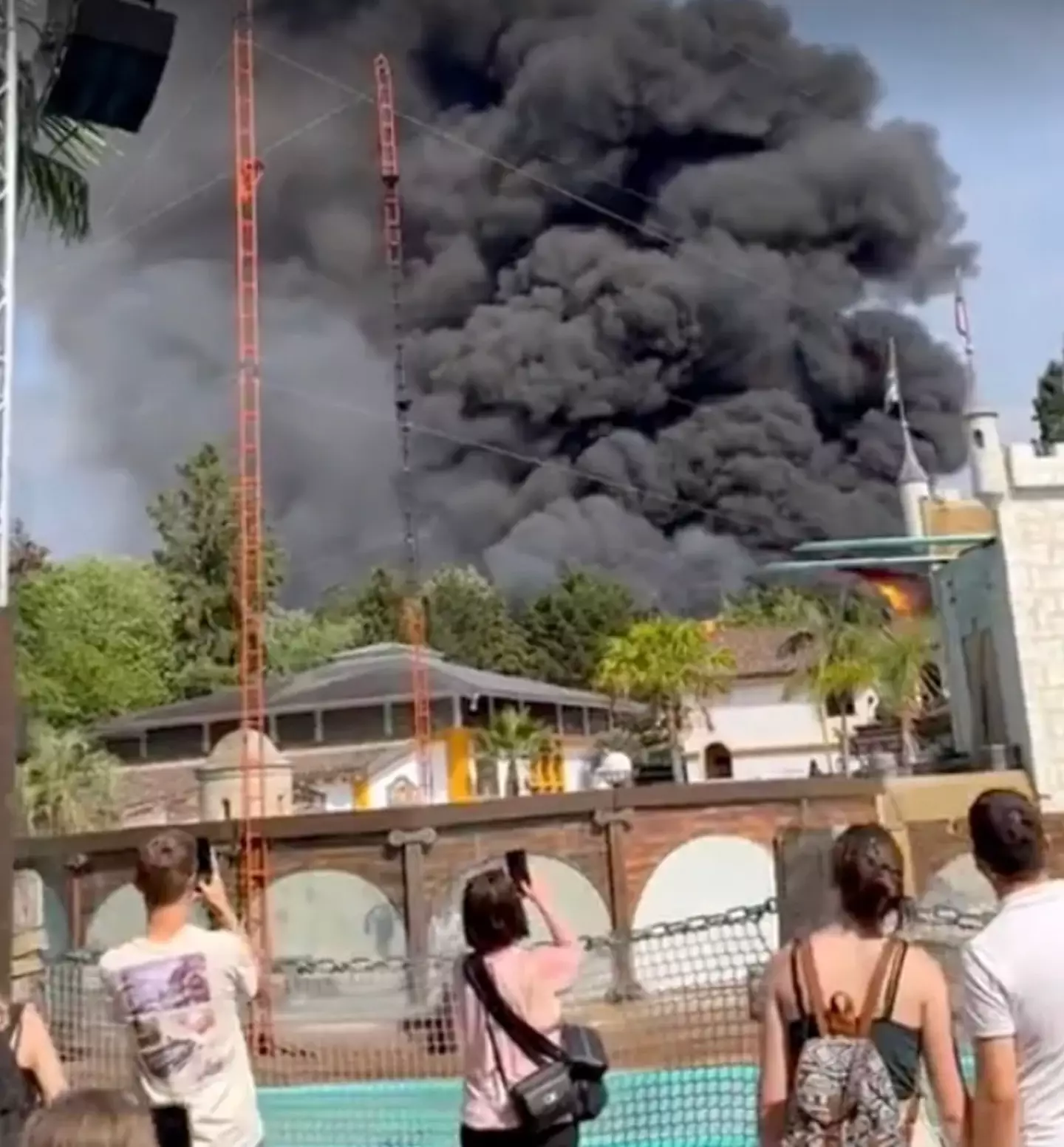 Park goers watch on as a huge fire breaks out at Europa-Park in Germany.