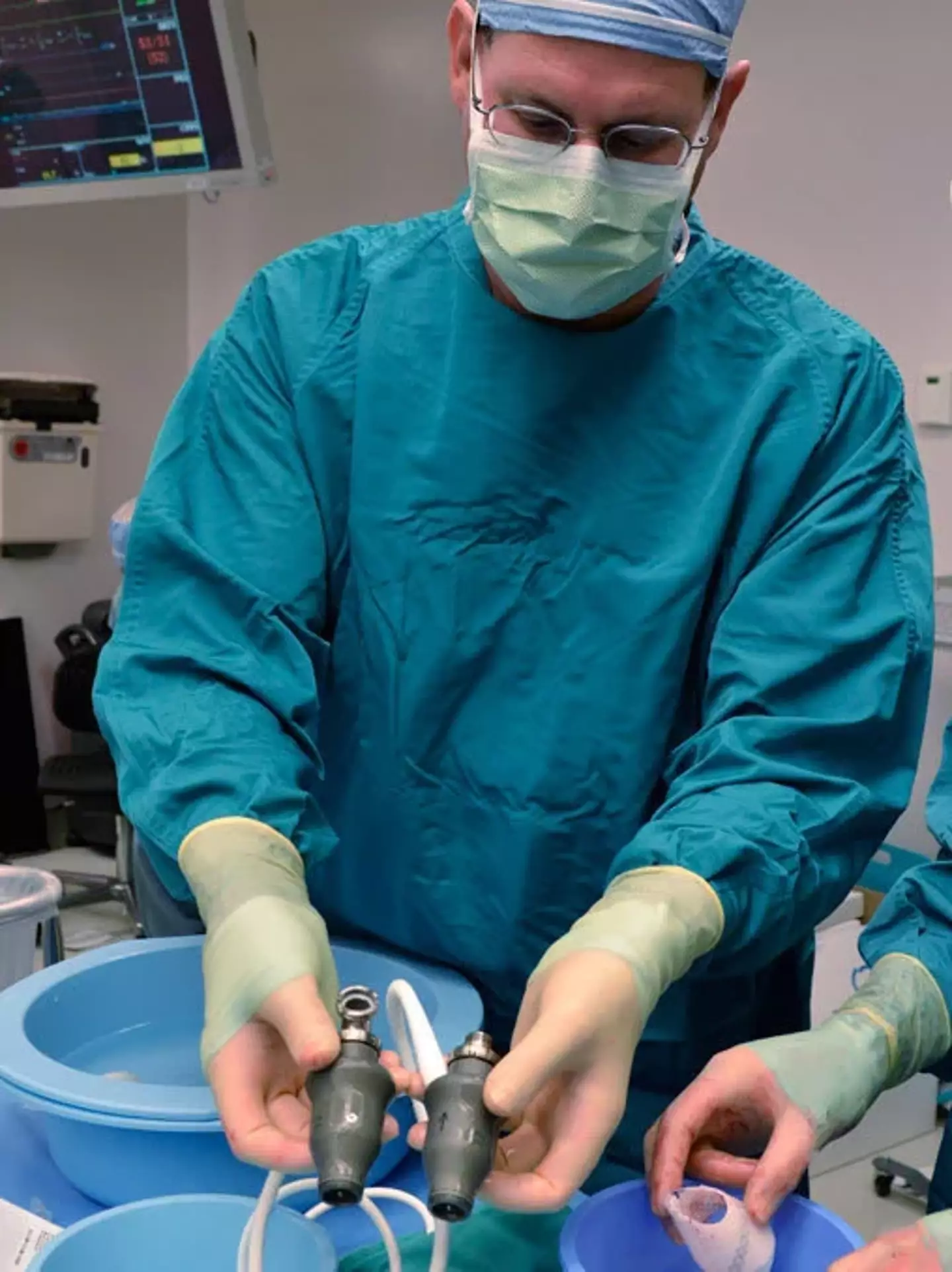 Steven Parnis, assistant director of technology development at the Texas Heart Institute, prepares the pair of devices for surgery.