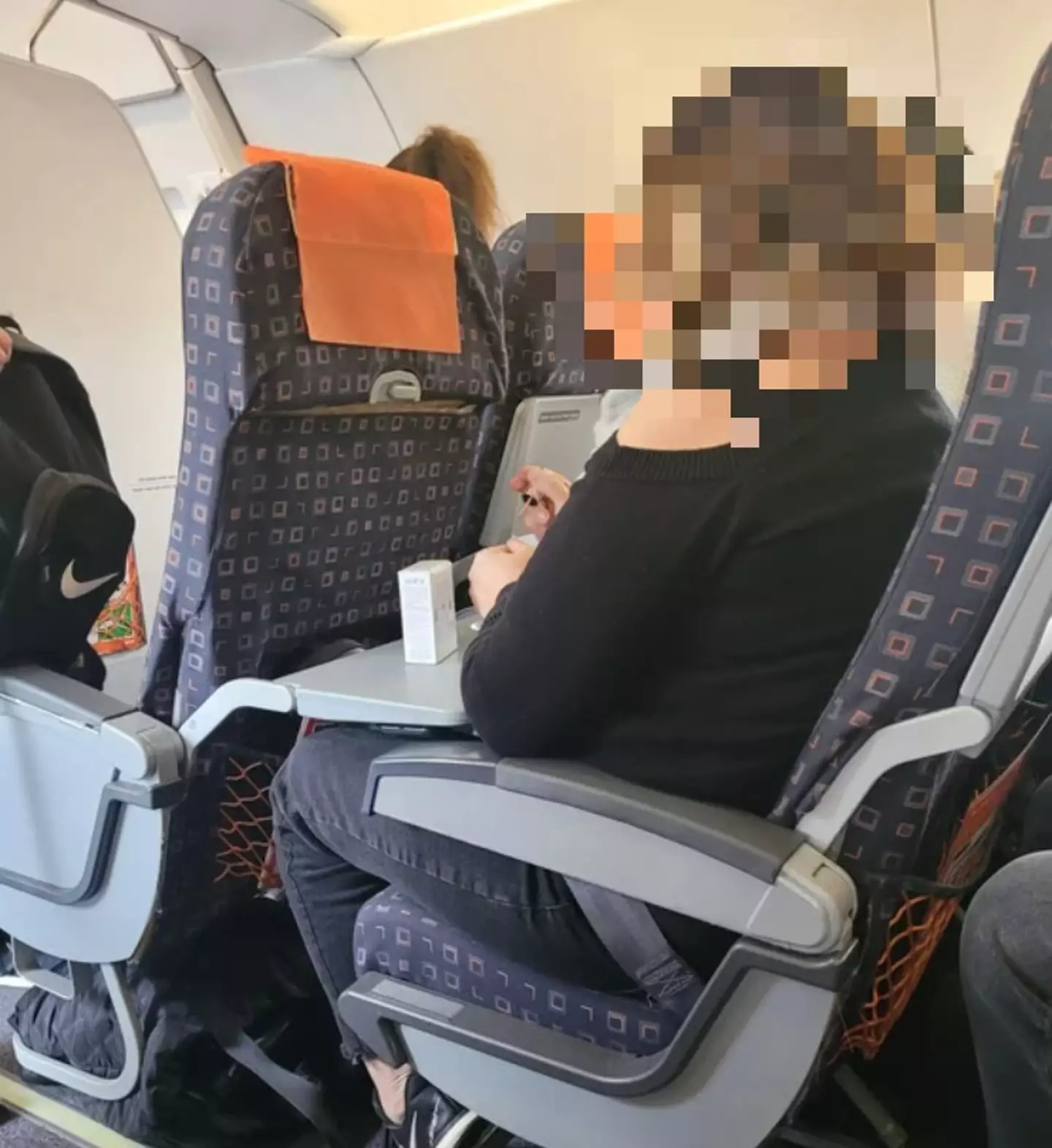 The woman was doing her nails on the plane.