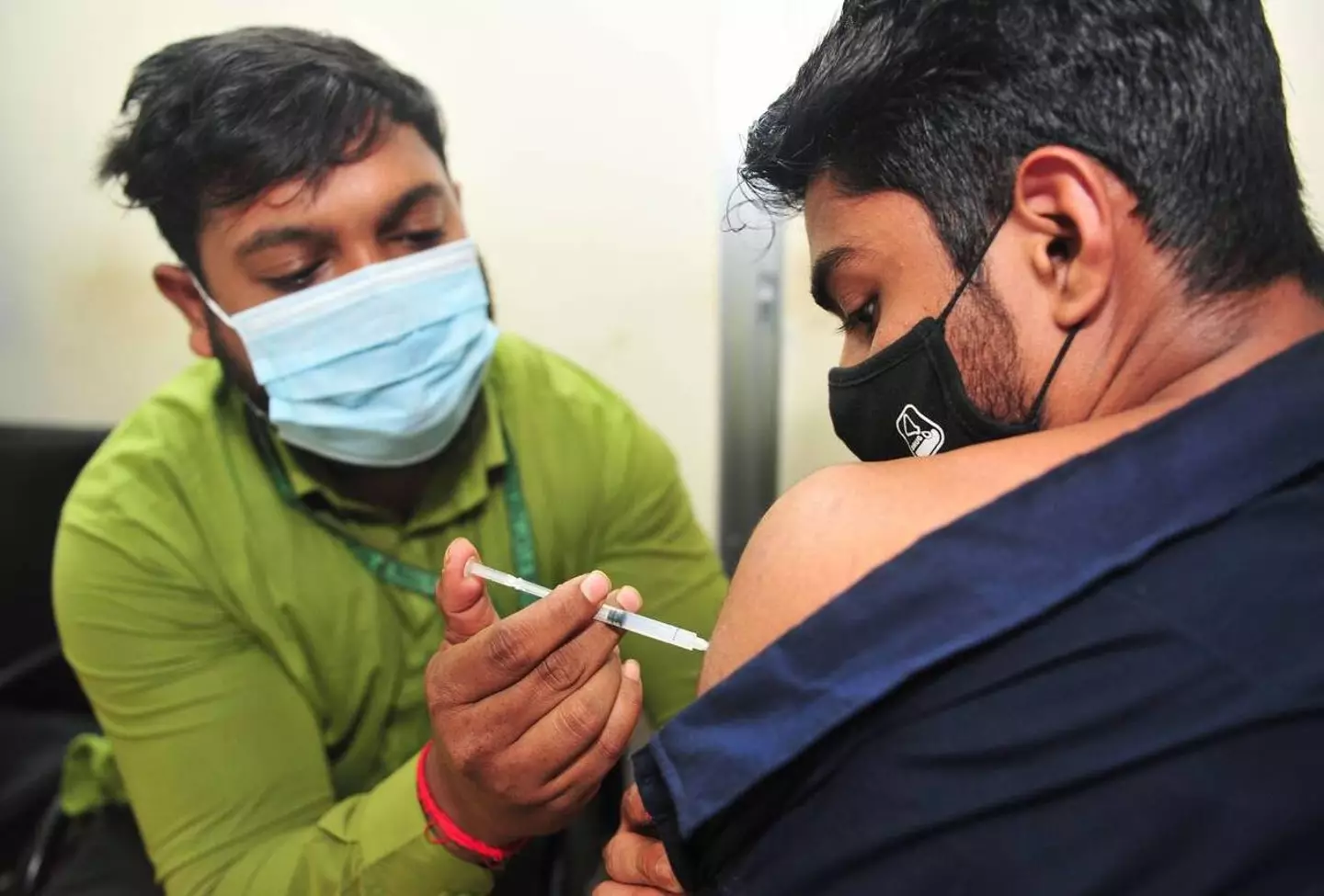 Health staff administer a vaccine