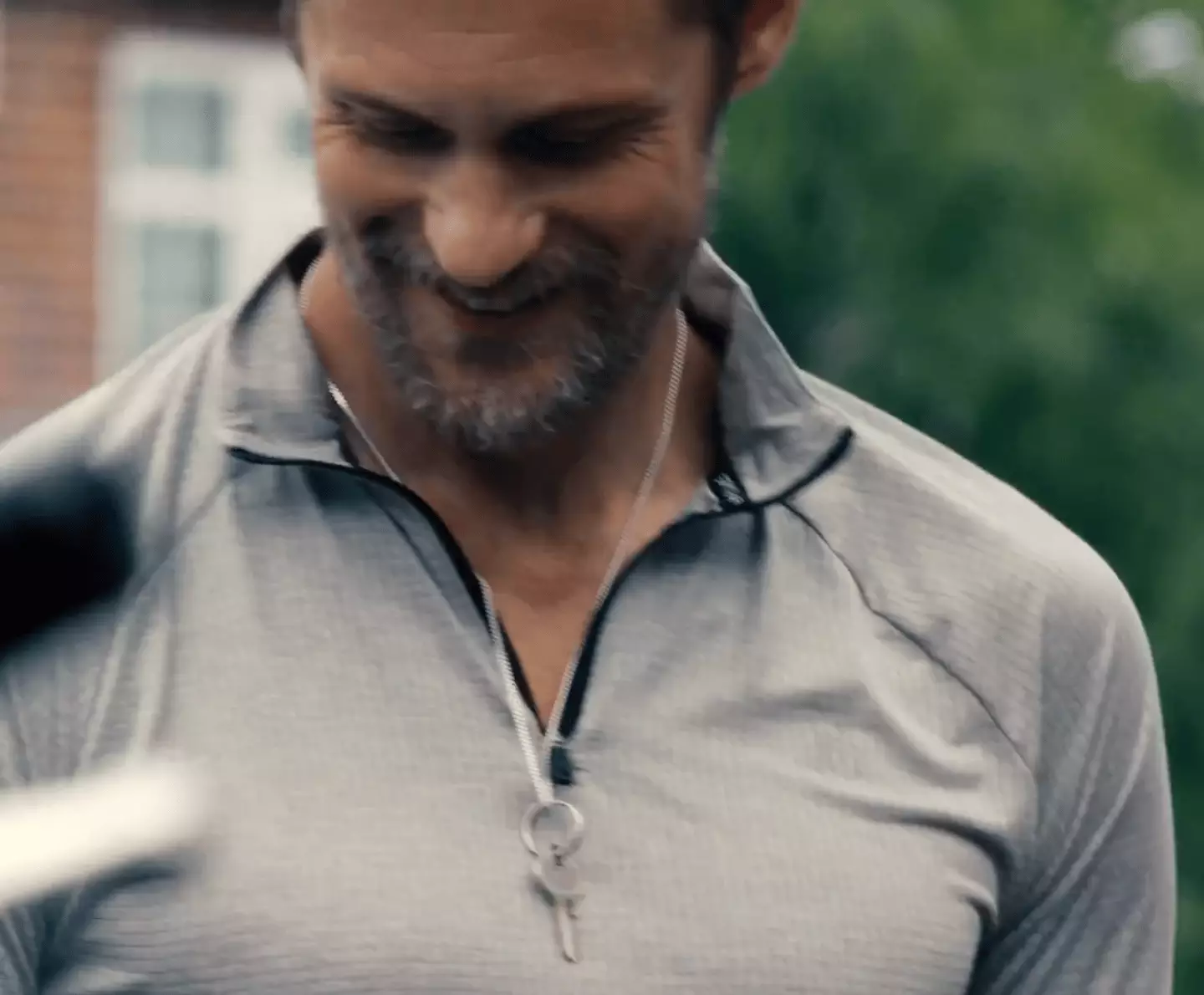 Alex Skarsgård's Ray is shown with a key on a chain around his neck (A24)