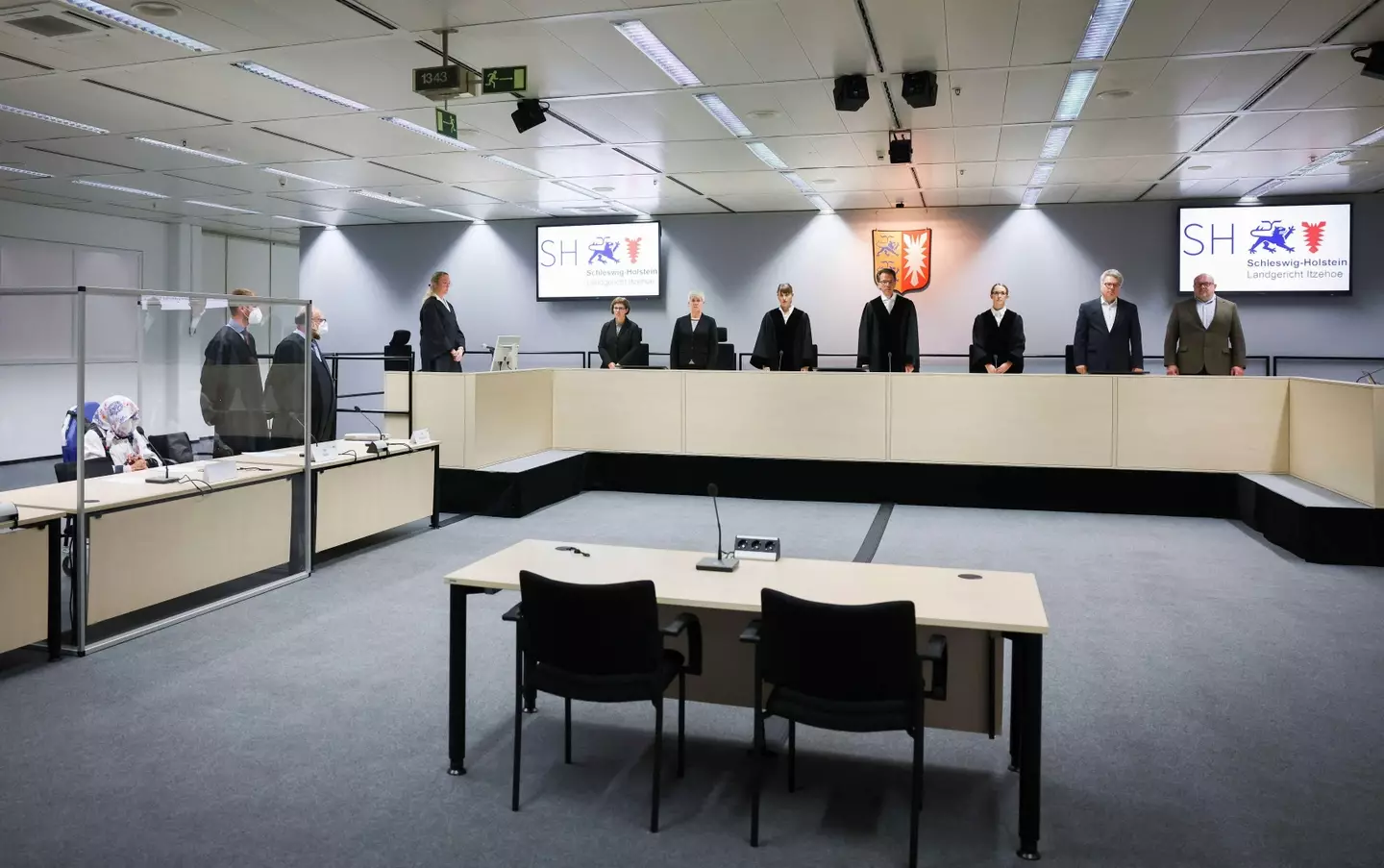 The trial is taking place in a courtroom in Itzehoe, Germany.