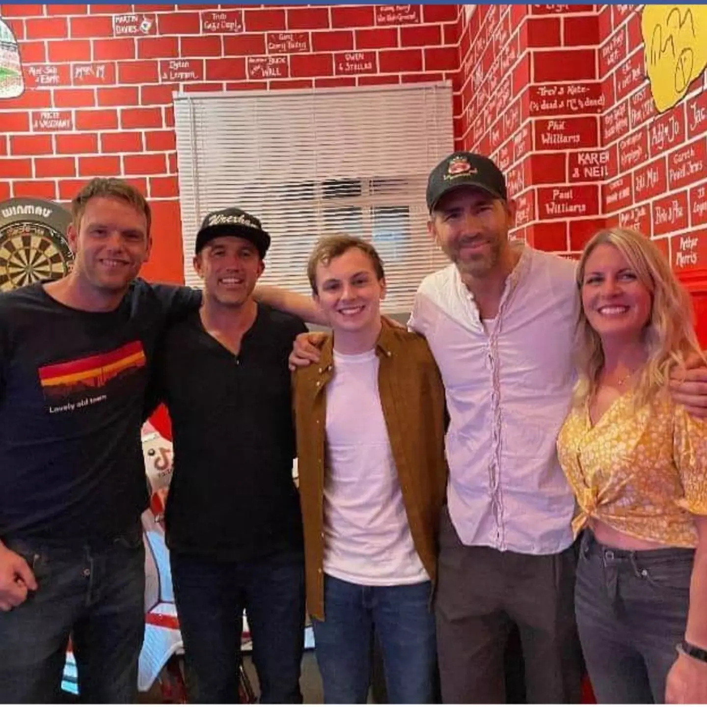The Turf landlord Wayne Jones and his family with Wrexham's celebrity owners.
