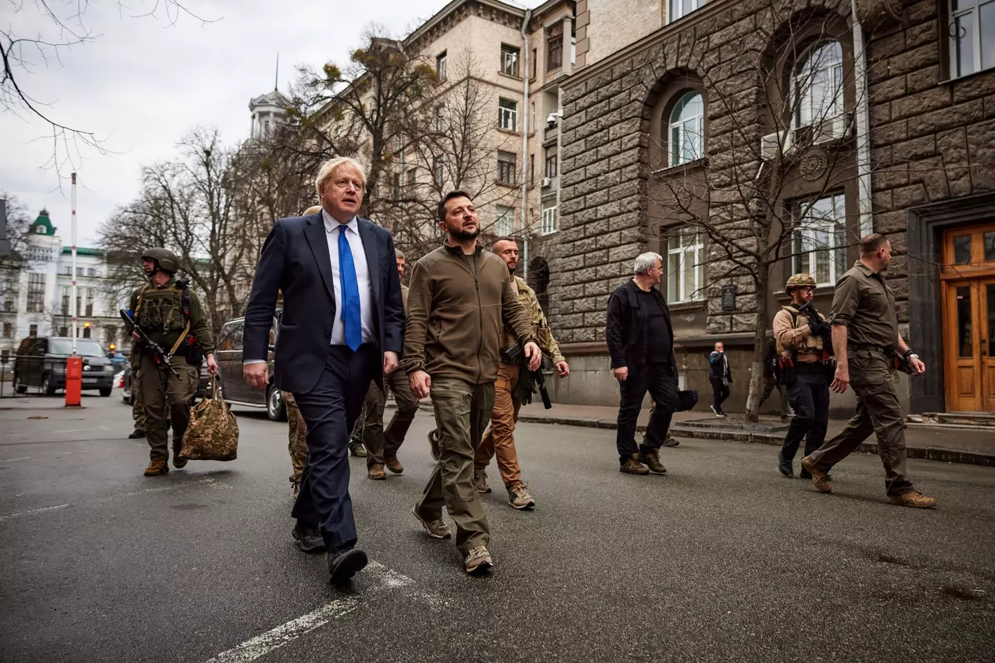 The President of Ukraine - Volodymyr Zelenskyy walks with Prime Minister of the United Kingdom - Boris Johnson through the streets of Kyiv with security forces.